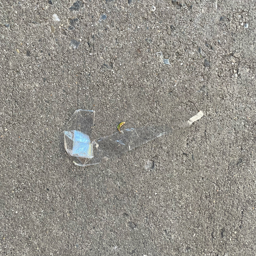 A photo of lost or discarded material found on a city street—with a form interpreted as resembling a pipe.