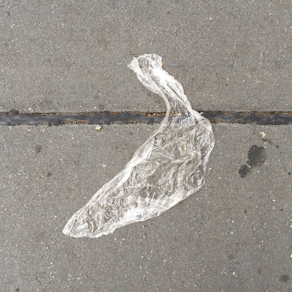A photo of lost or discarded material found on a city street—with a form interpreted as resembling a banana.