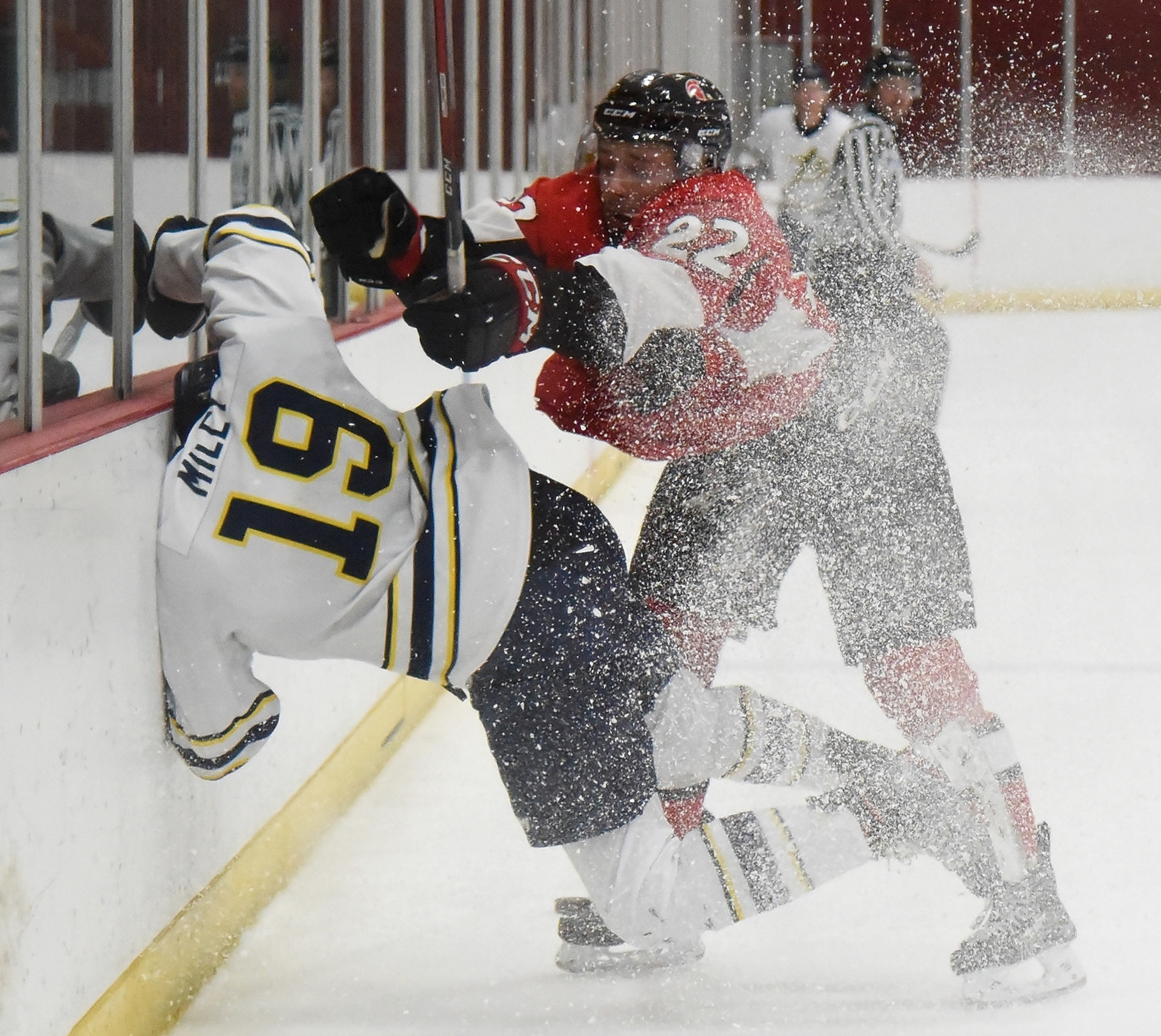 Trojan Kaden Hanas drives Ryan Miley into the boards during a game against Briercrest College in men’s Alberta Colleges Athletic Conference hockey action at the Campus Centre Arena at SAIT in Calgary on Saturday, Nov. 13, 2021.