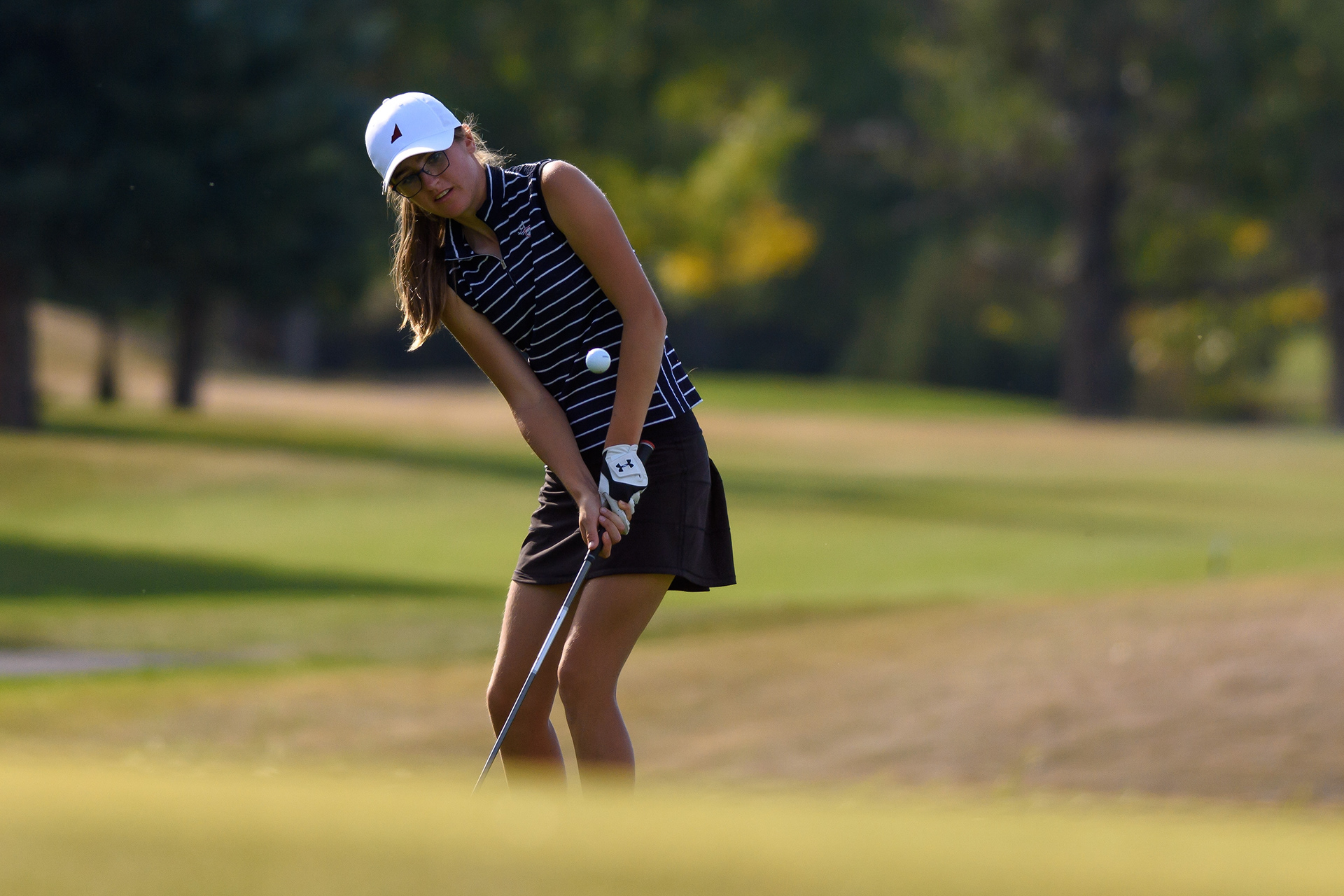 Tessa Ion, from Rundle College, pitches onto the 18th green during the ASAA Provincial Golf Championships at the Highwood Golf and Country Club in High River on Sept. 27, 2022.