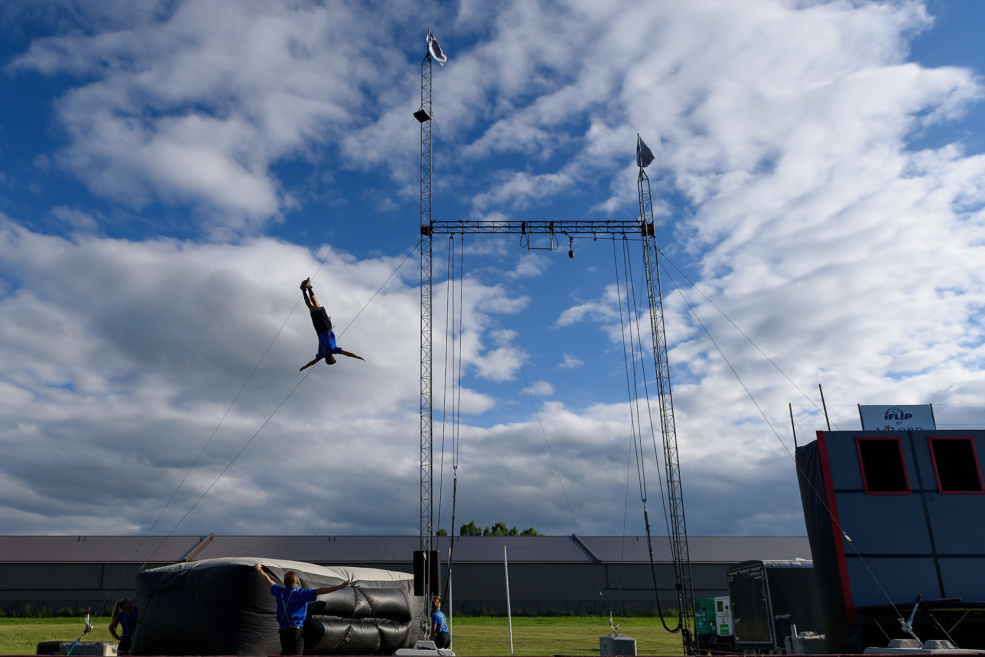 An acrobat does a high fall to close out a live acrobatic show by Milord Entertainment during Okotoks Ribfest at the Okotoks Agricultural Society on Aug. 5, 2022