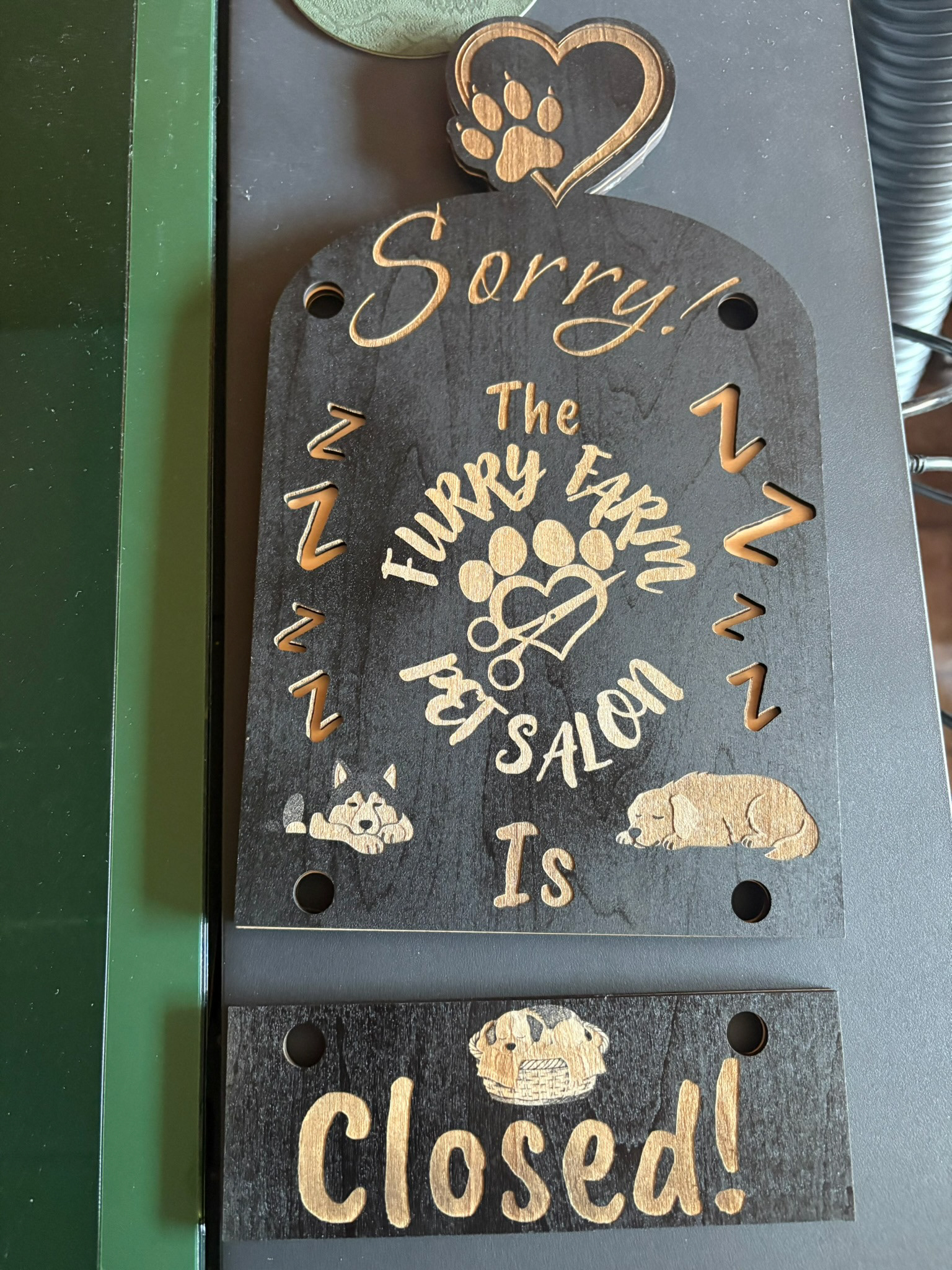 Back of the open closed sign for dog groomer.