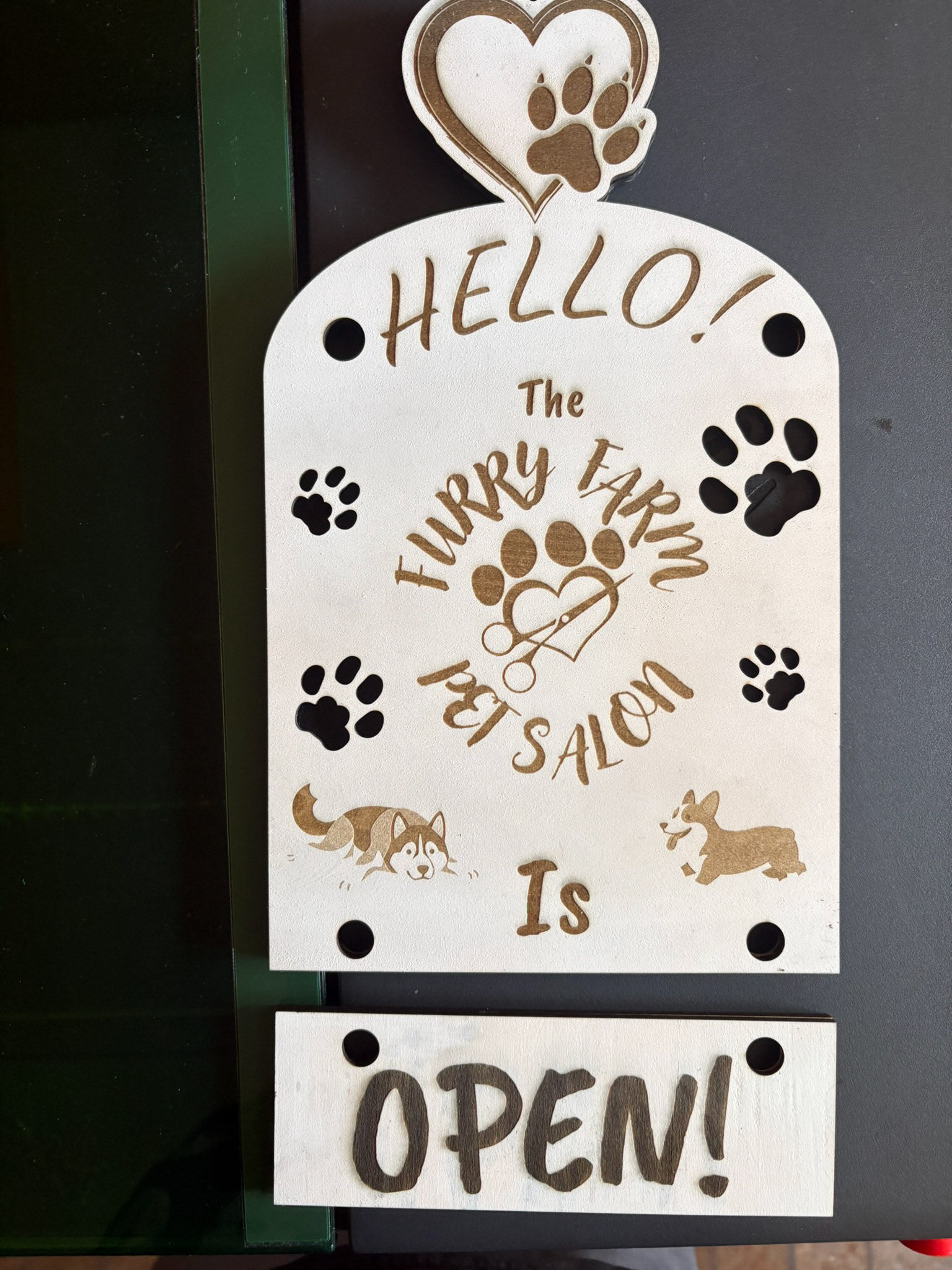 Front of an open closed sign for our dog groomer.