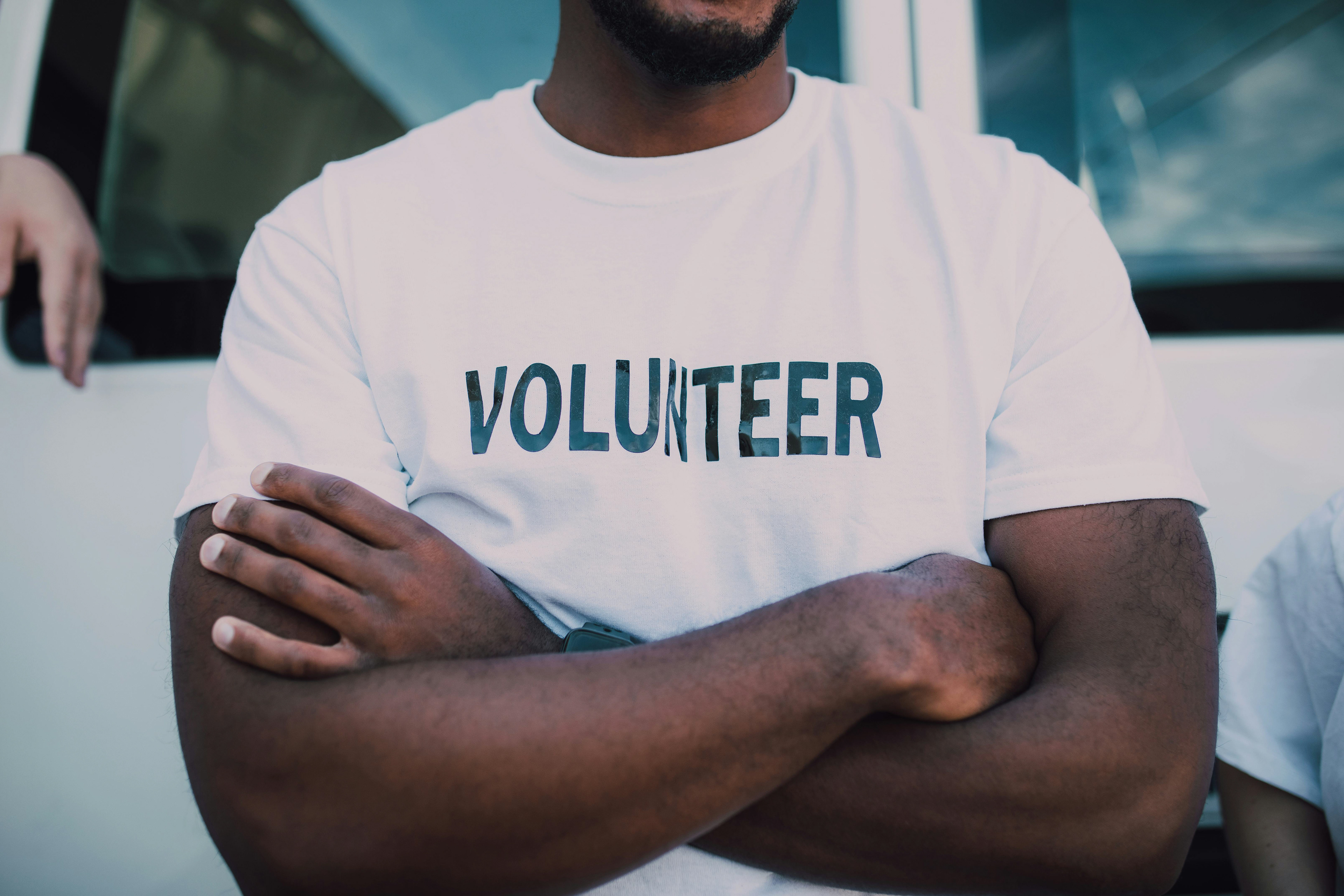 African American man wearing a volunteer shirt with the CLVR LABs logo.