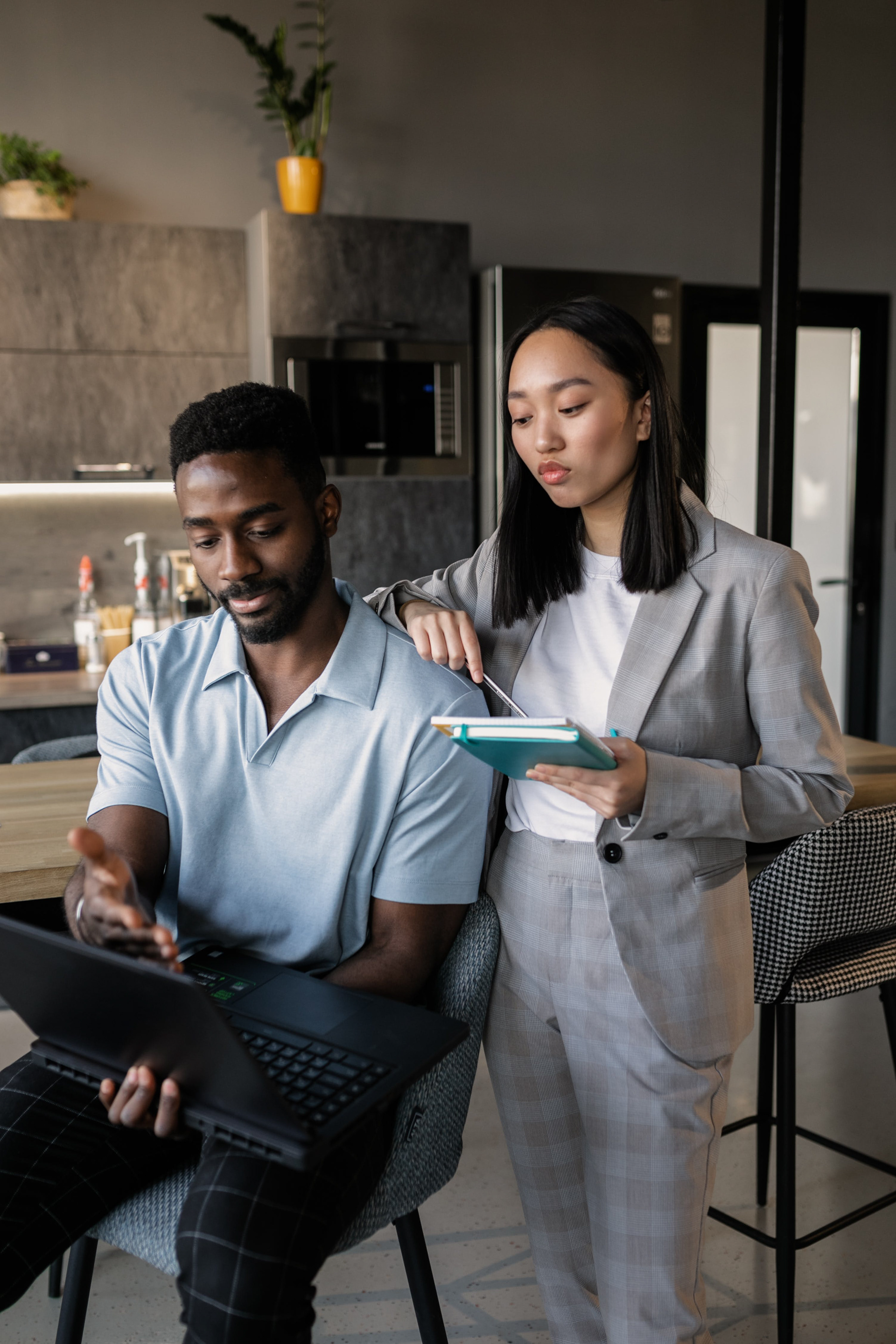 Asian woman and man engaged in discussion during a CLVR LABs workshop.