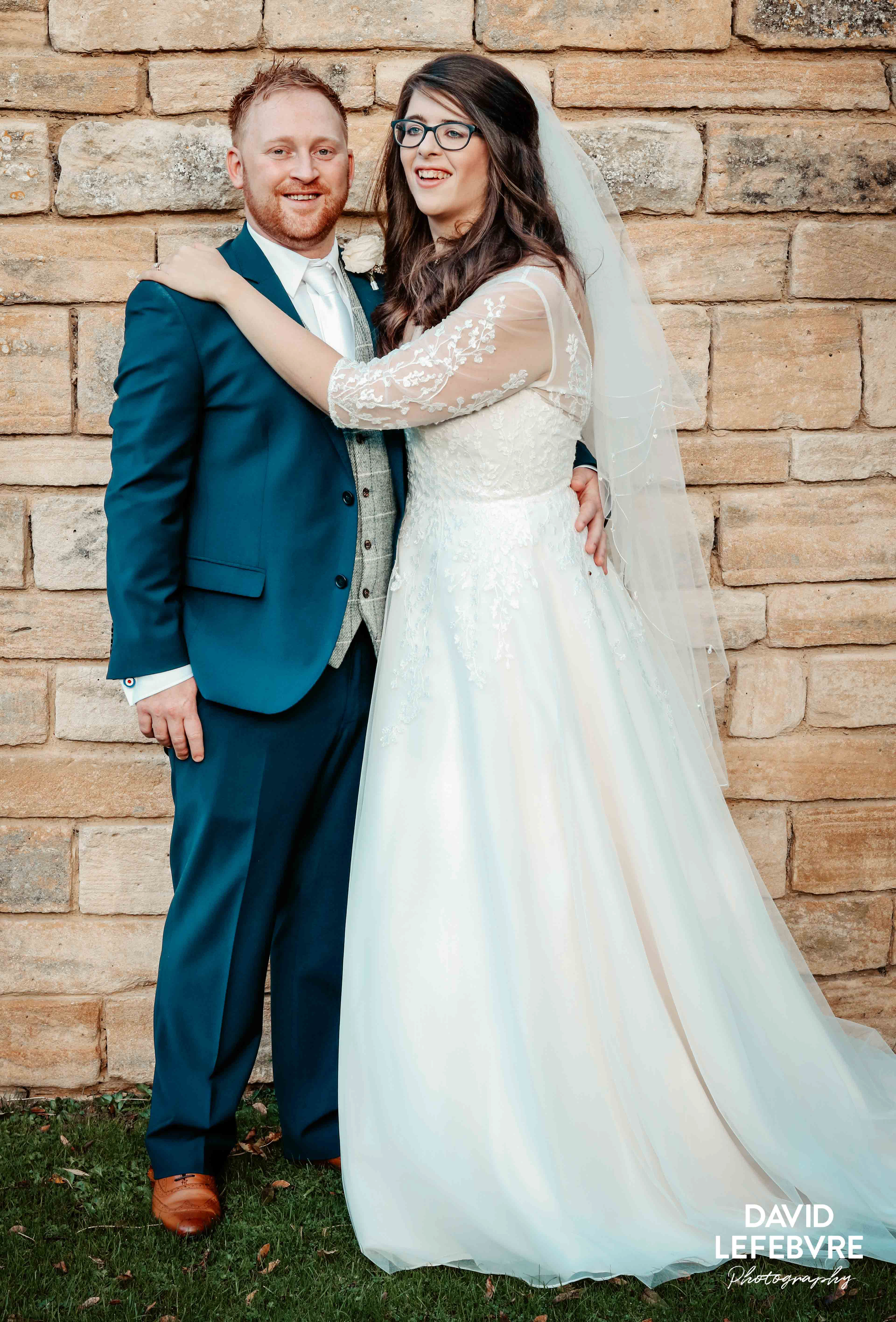 bride and groom smiling arm in arm at bay tree wedding