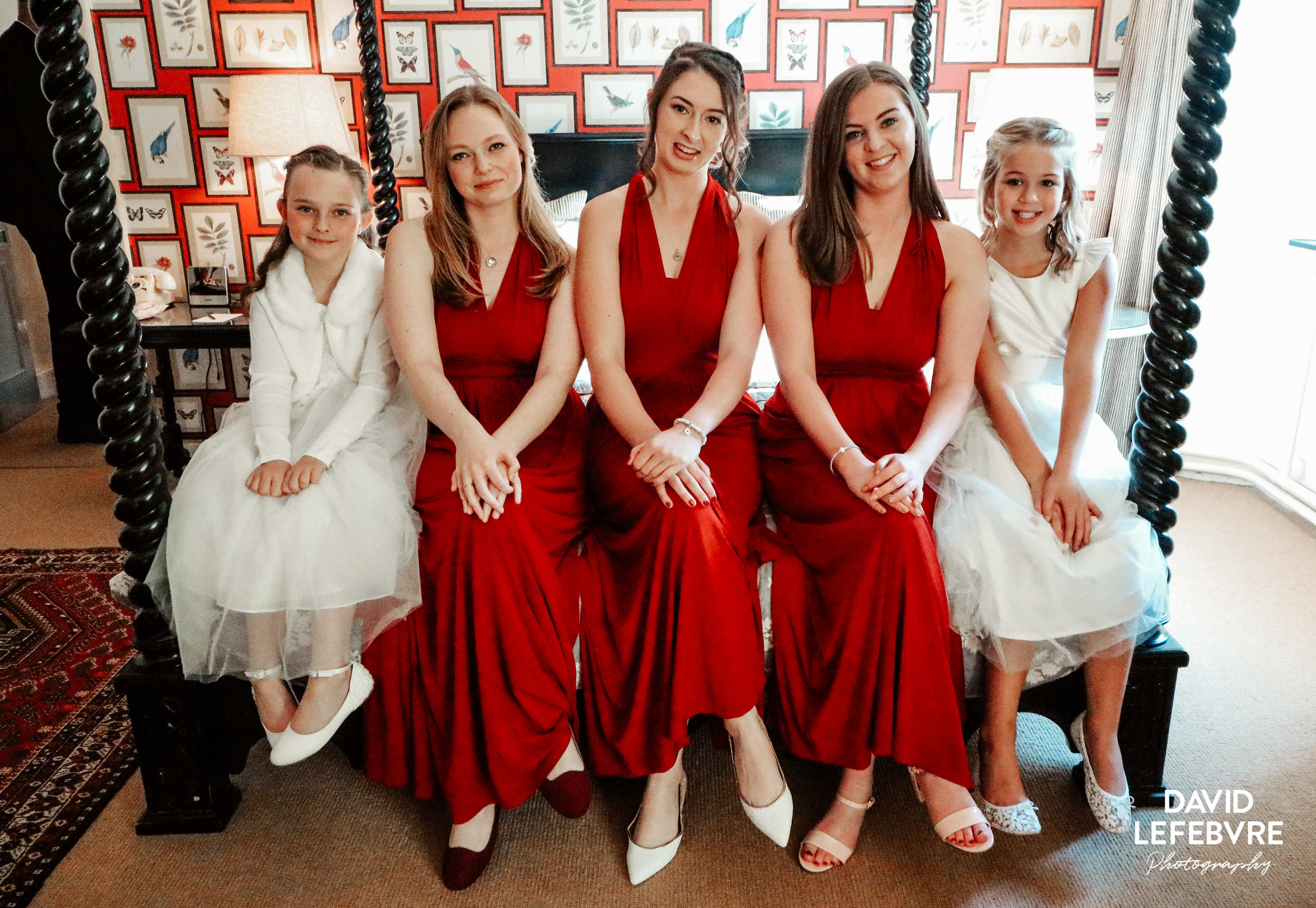 bridal party in red dresses with flower girls
