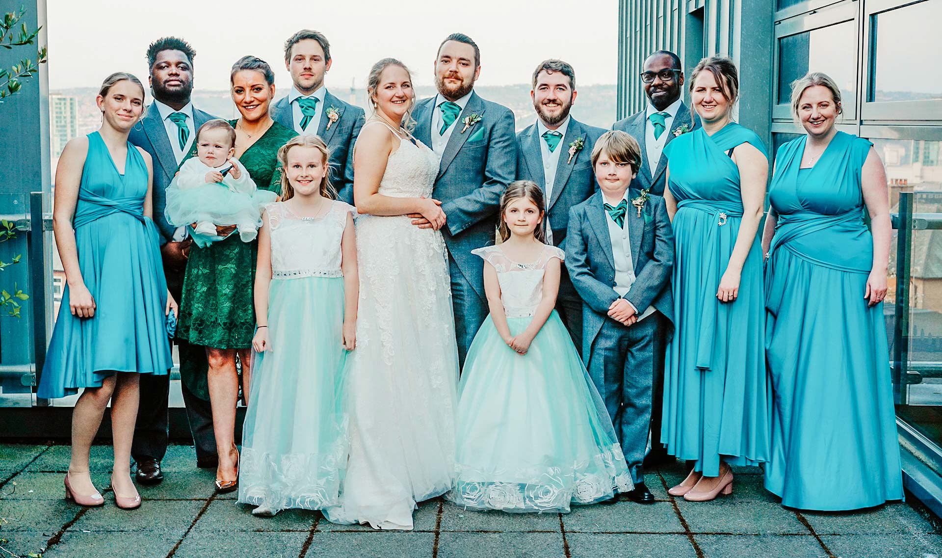 top 10 must have family photo wedding shots in blue and grey suits smiling on balcony in sheffield taken by david lefebvre photographer from buckinghamshire