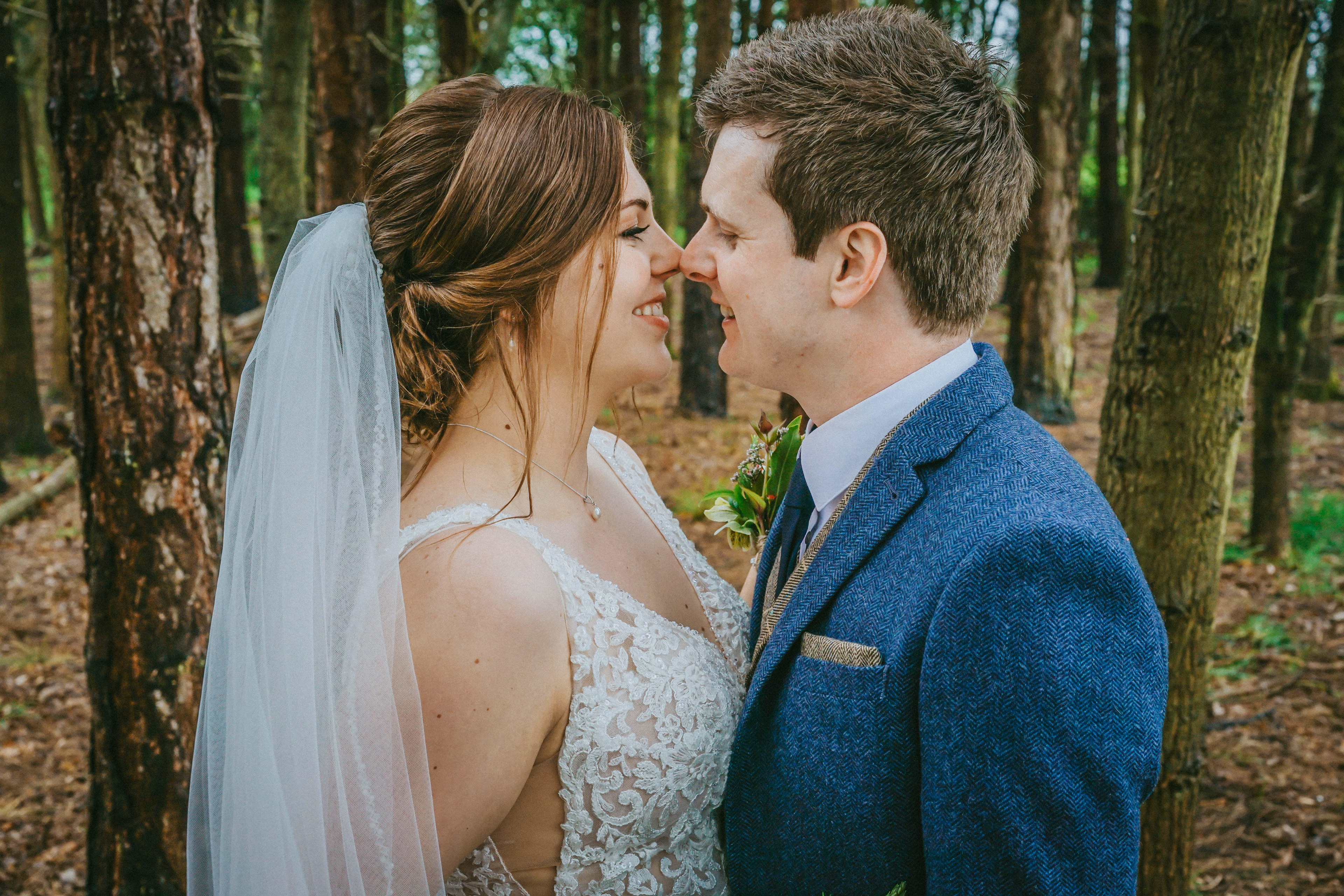 bride and groom look into each others eyes smiling surrounded by woodland at endeavour woodland wedding venue in swanbourne buckinghamshire taken by local wedding photographer david lefebvre