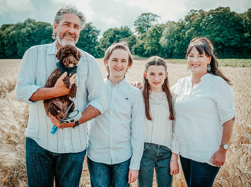 happy family with dog in wheat field in oxfordshire england near blenheim palace with david lefebvre portrait photographer