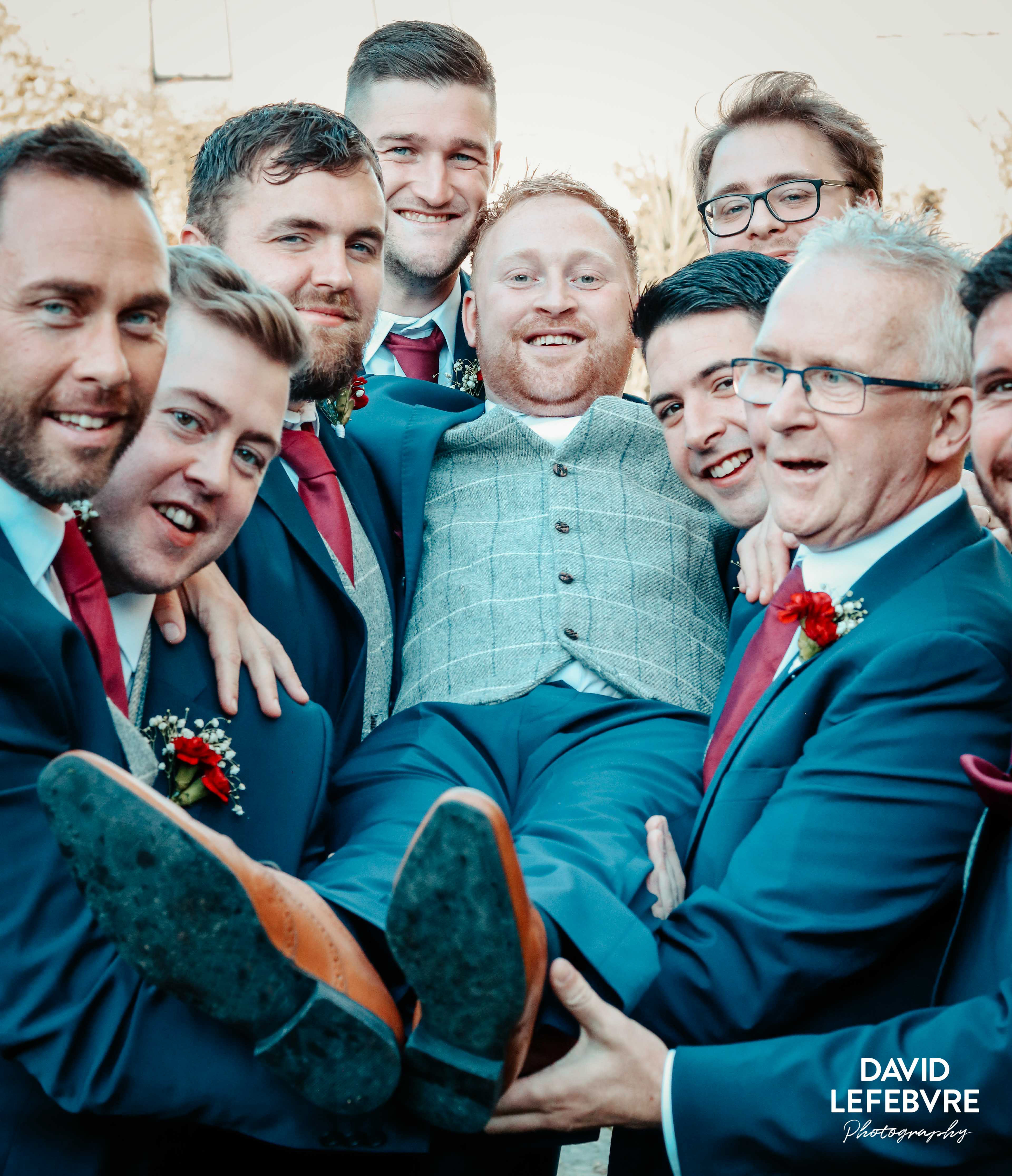 groom carried by groomsmen and dad at bay tree wedding