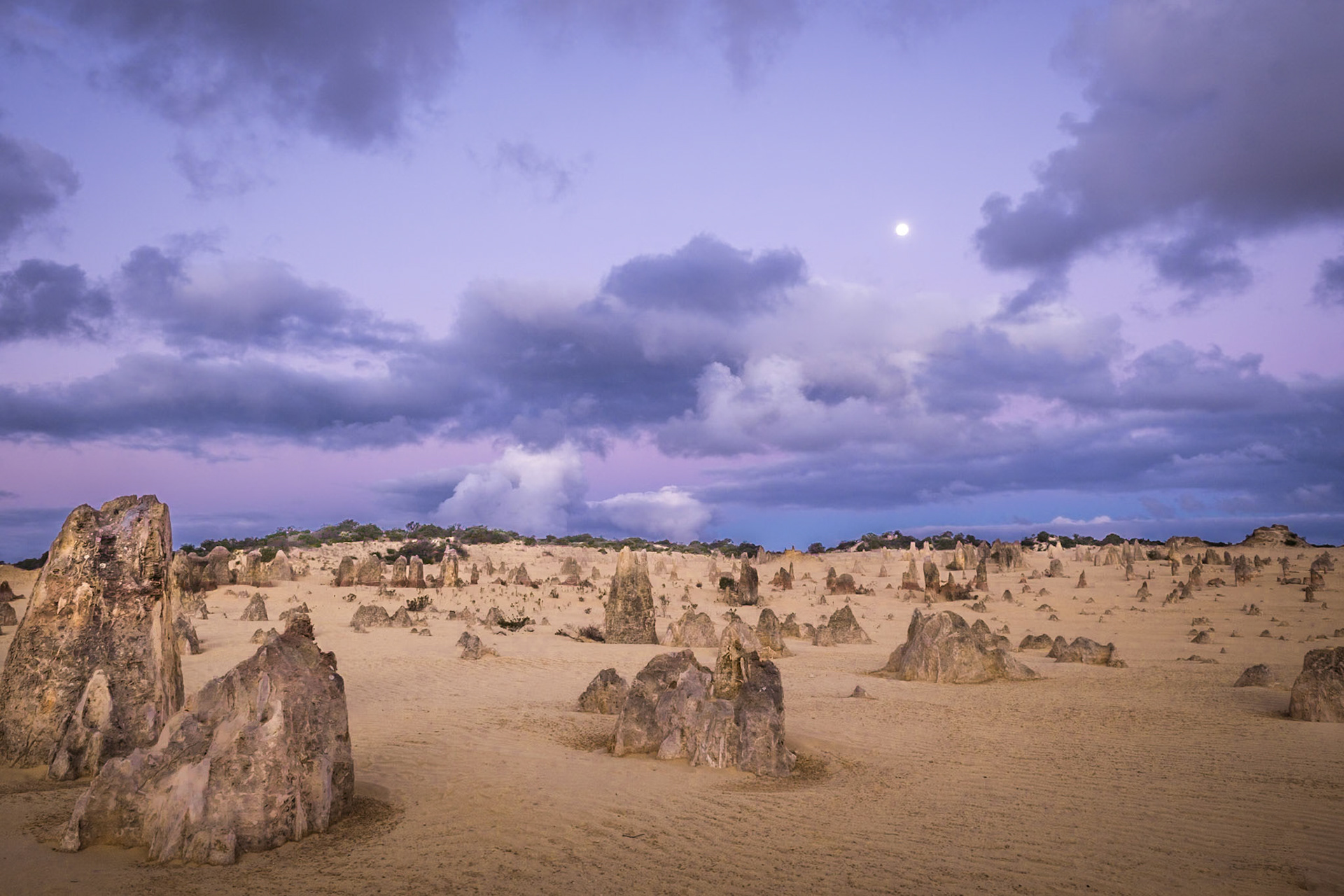 Clouds move in with the full moon at this other worldly scene.