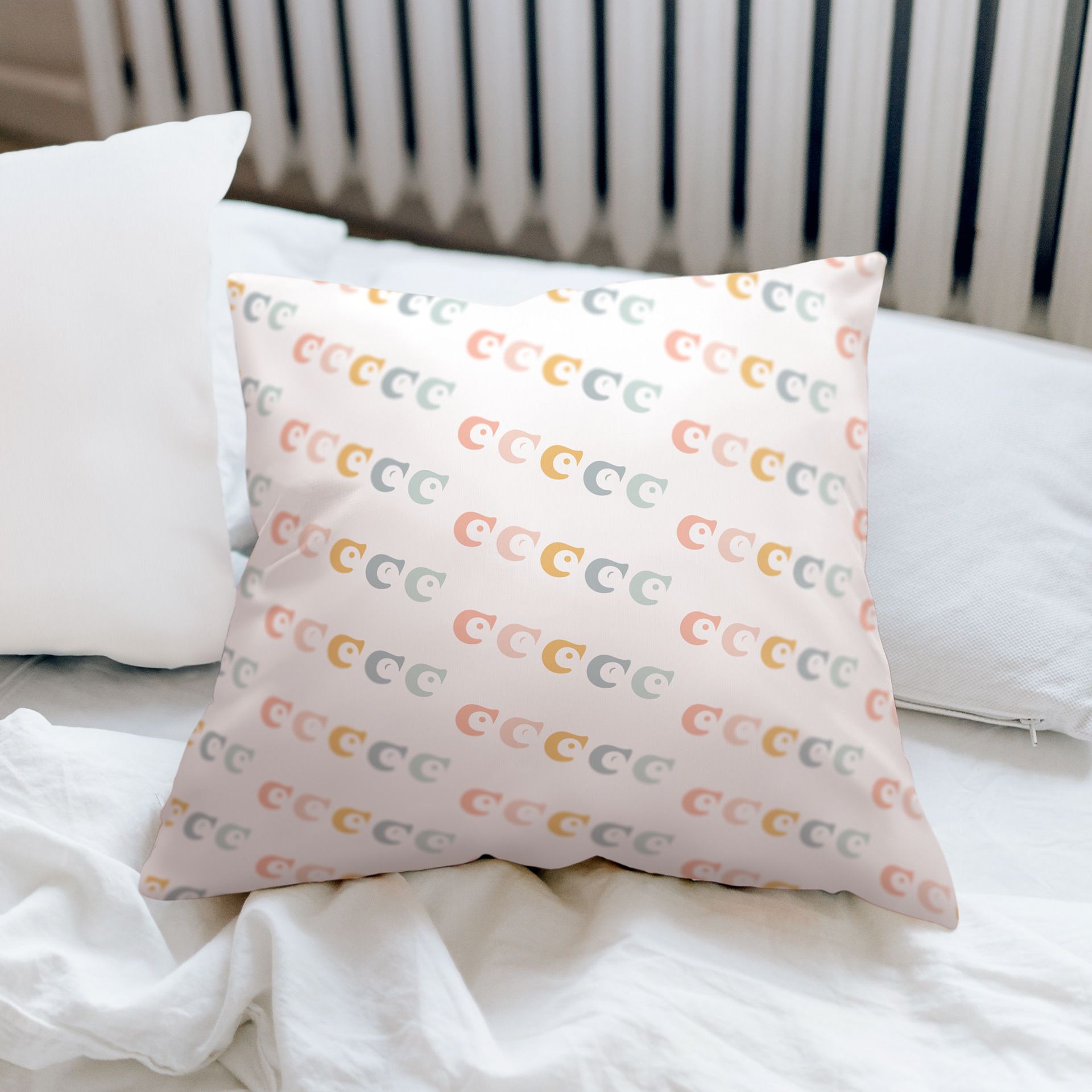 Baby Mine pillow showcasing the brand element pattern