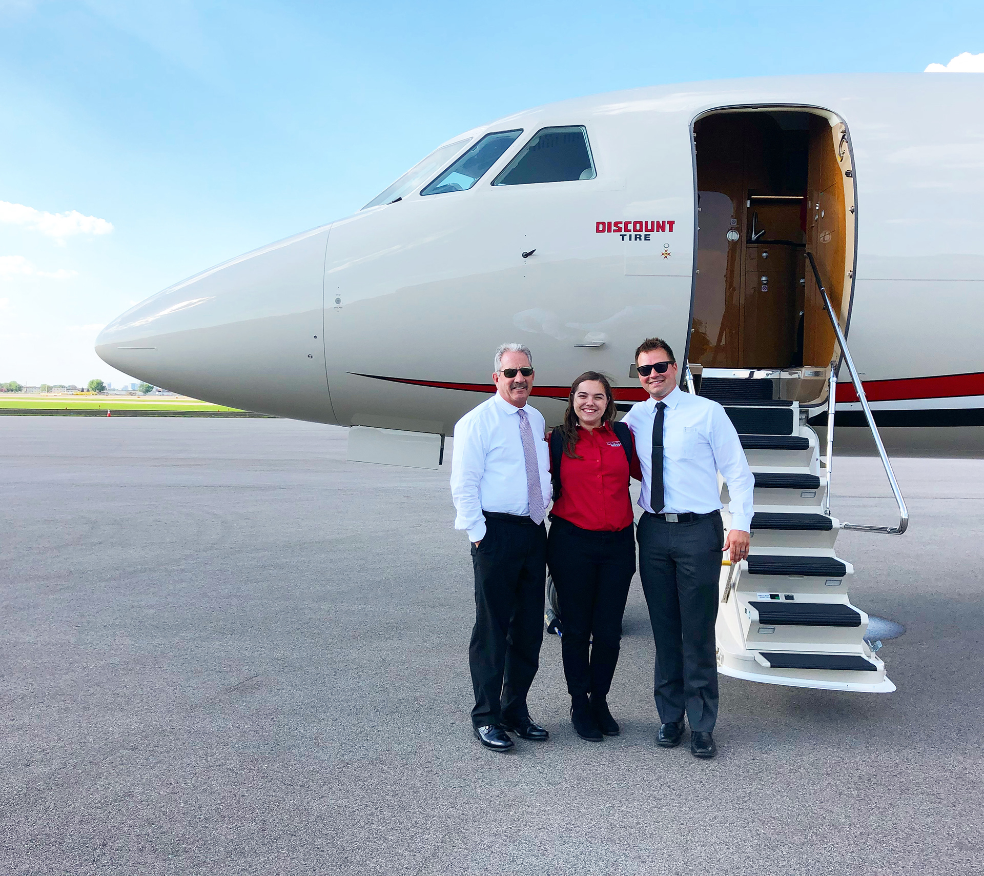 Mary with the pilots who flew her around the country to interview and test users for Discount Tires new in-store products