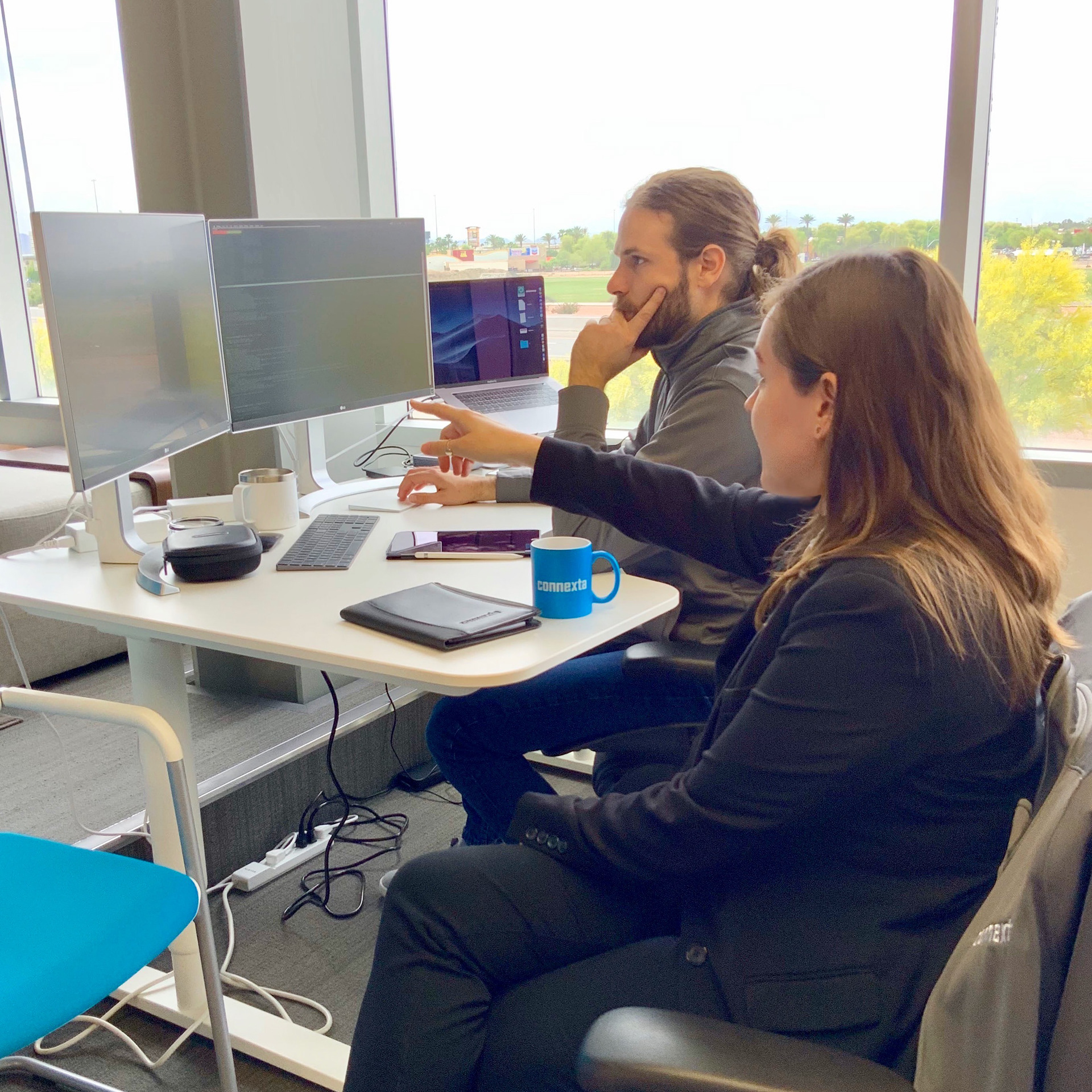 Mary giving UX advice to her teammate at Connexta