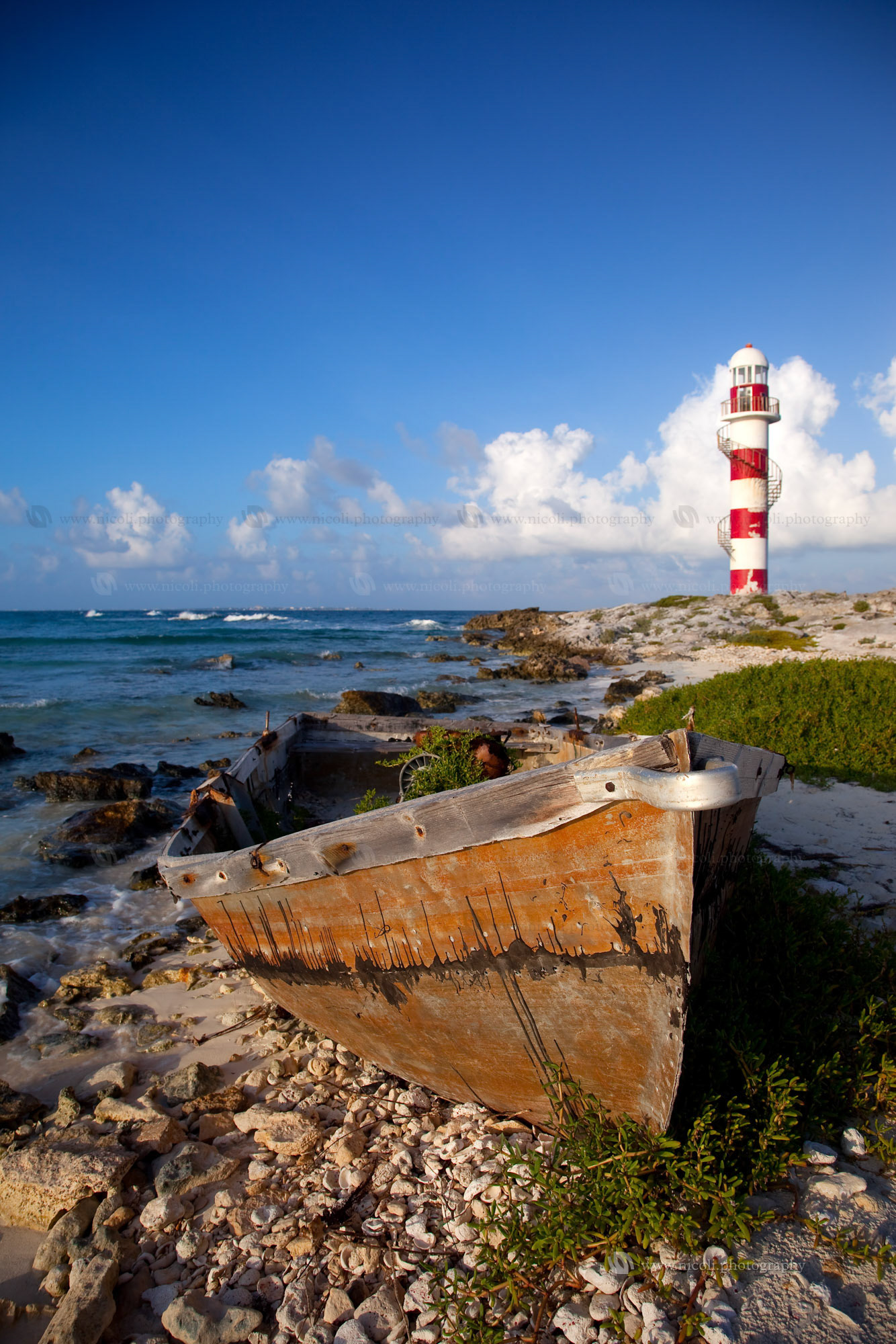 Lighthouse and rusty boat in Punta Cancun Mexico
