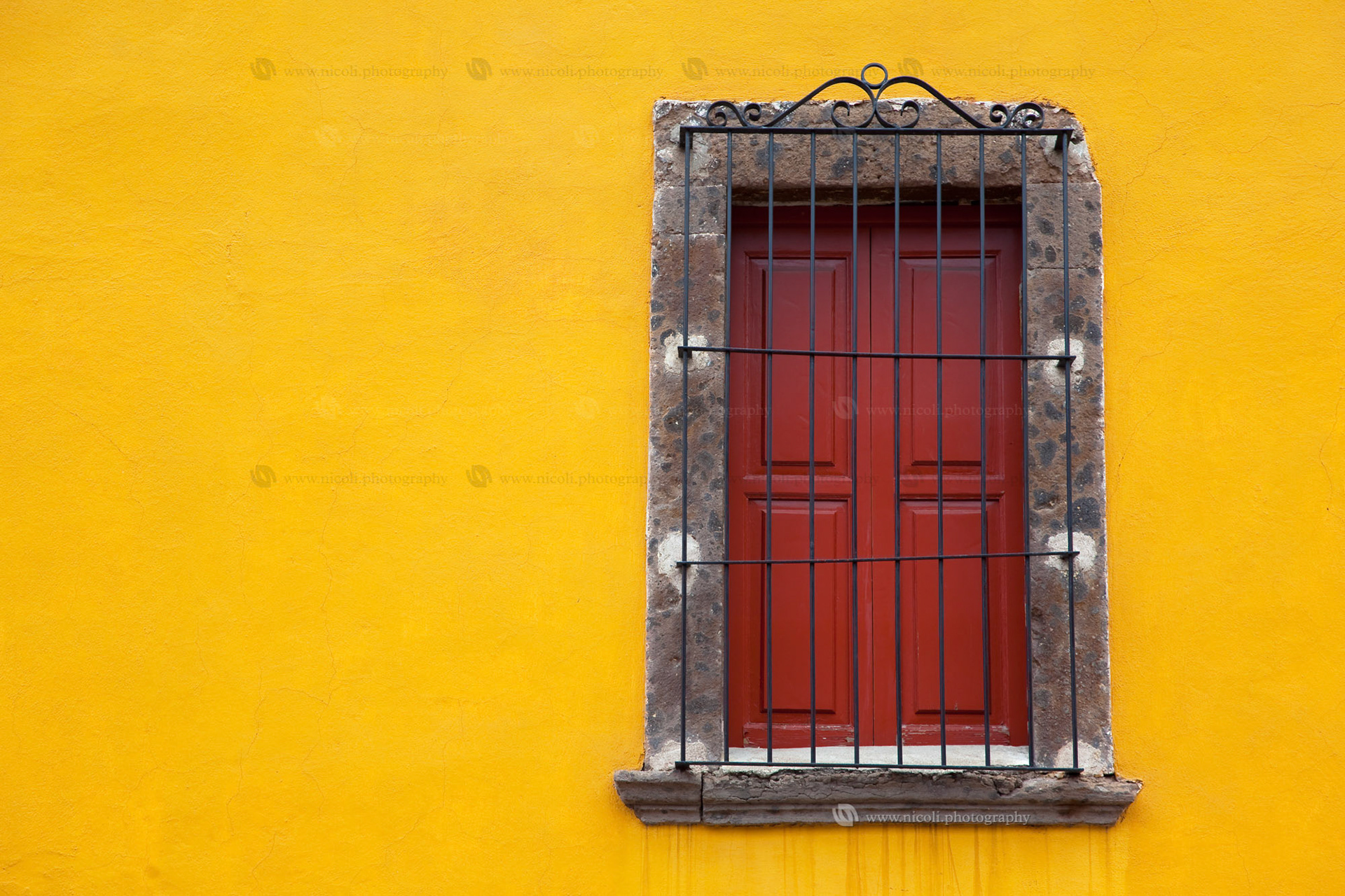 Old yellow window in old town. Mexico