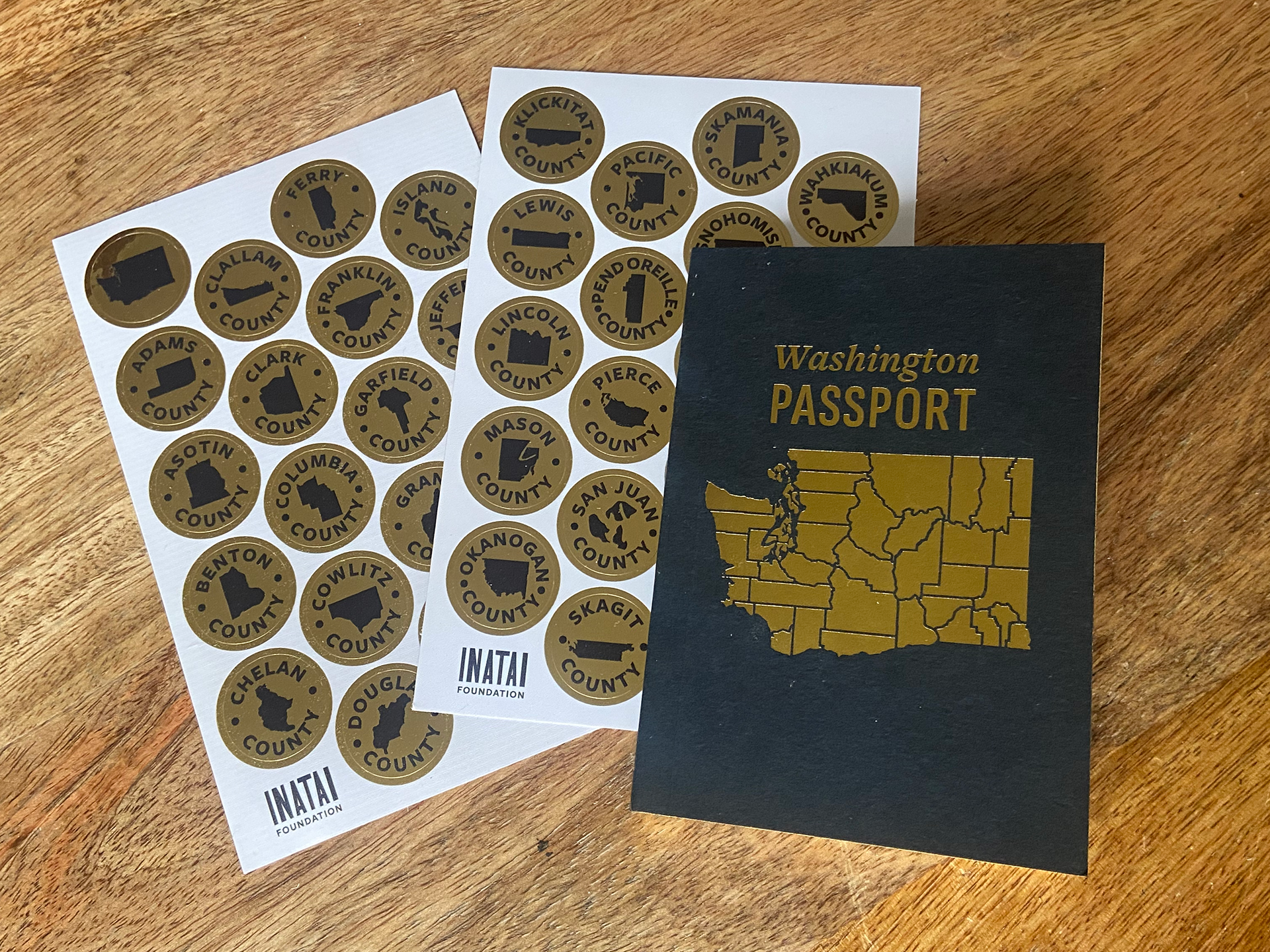 Washington State passport with gold stickers for each county
