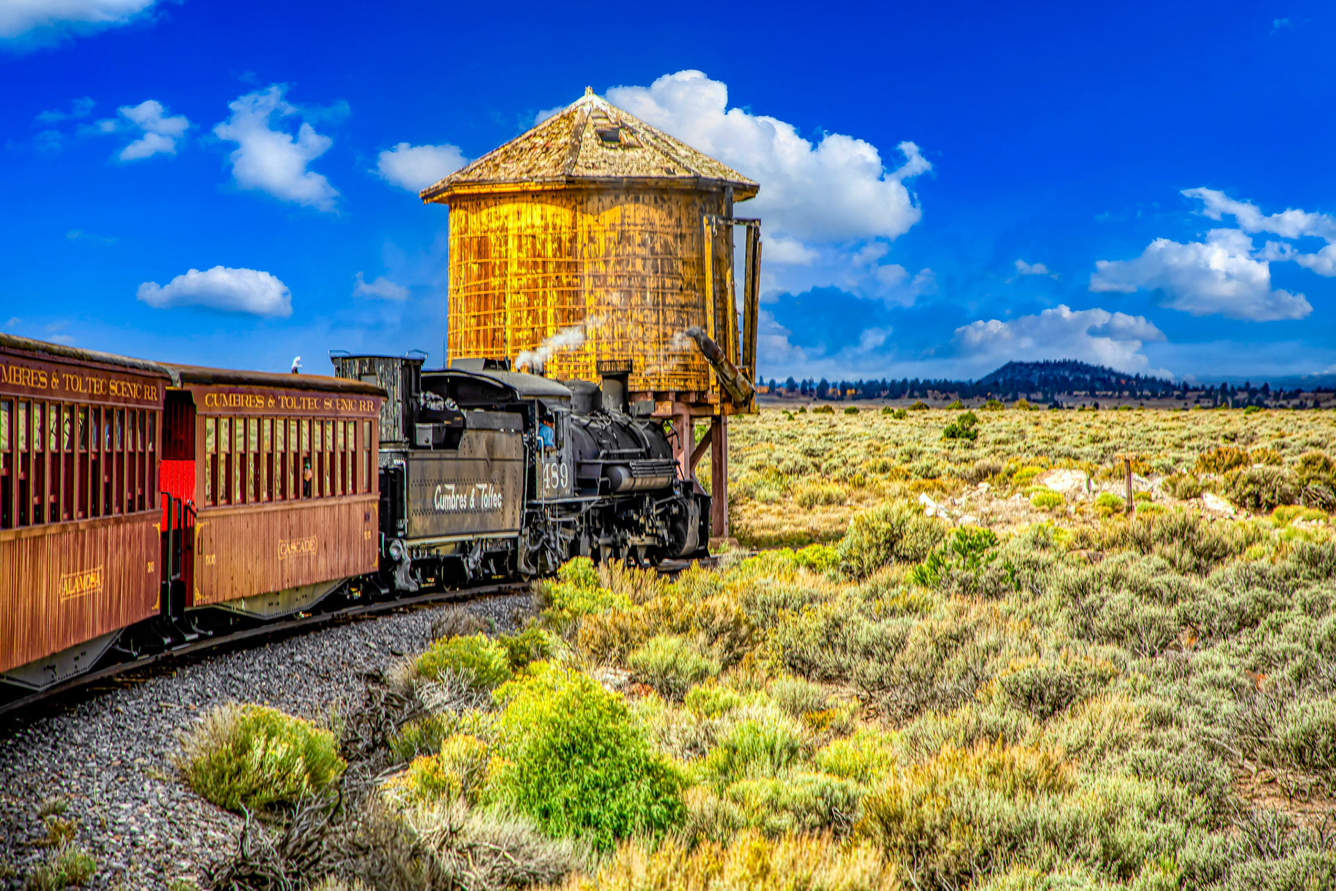 Rio Grande No. 489 engine is on the Cumbres and Toltec Scenic Railroad passes a water tower