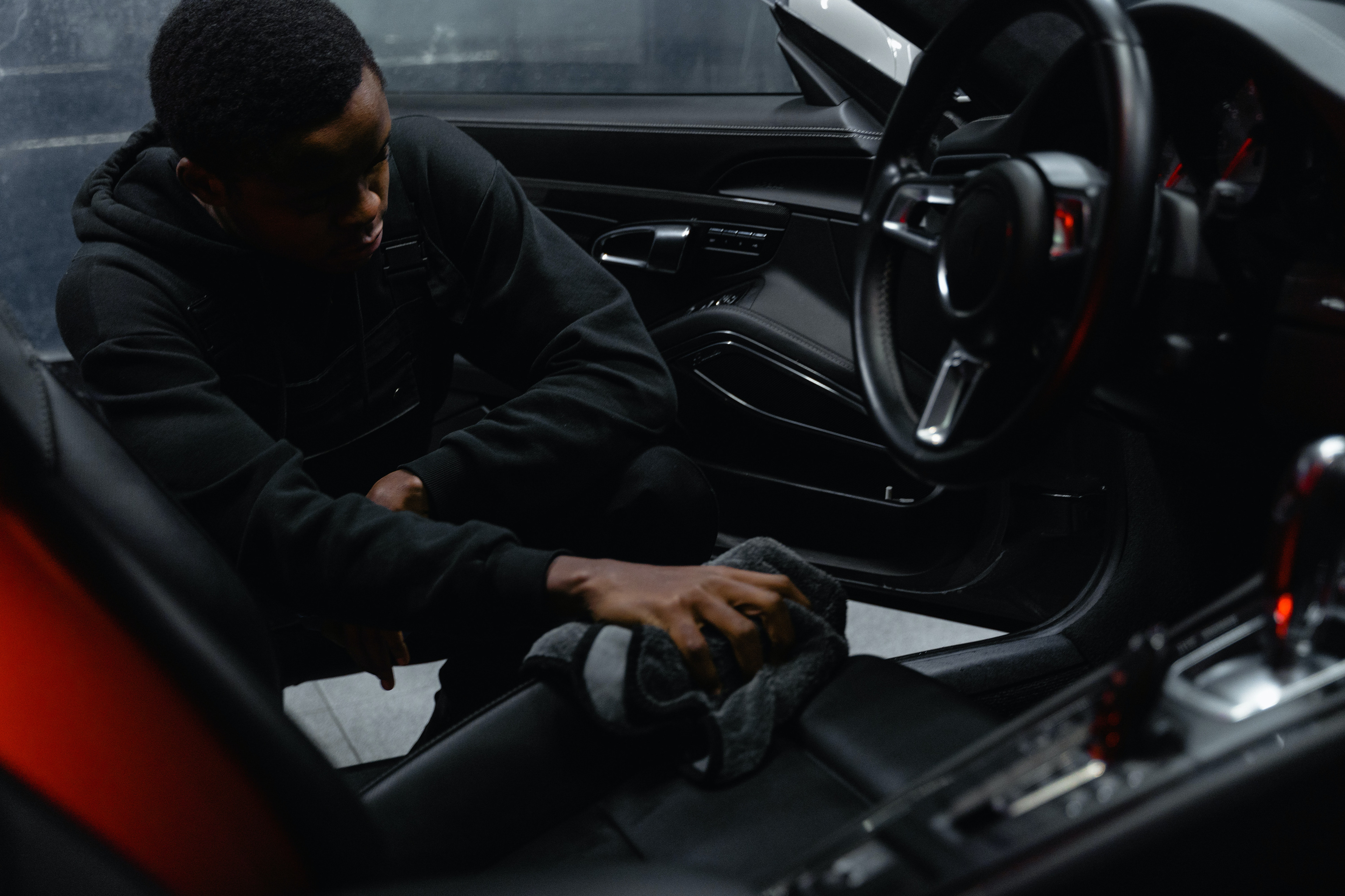 Man in the process of detailing the interior of an Audi