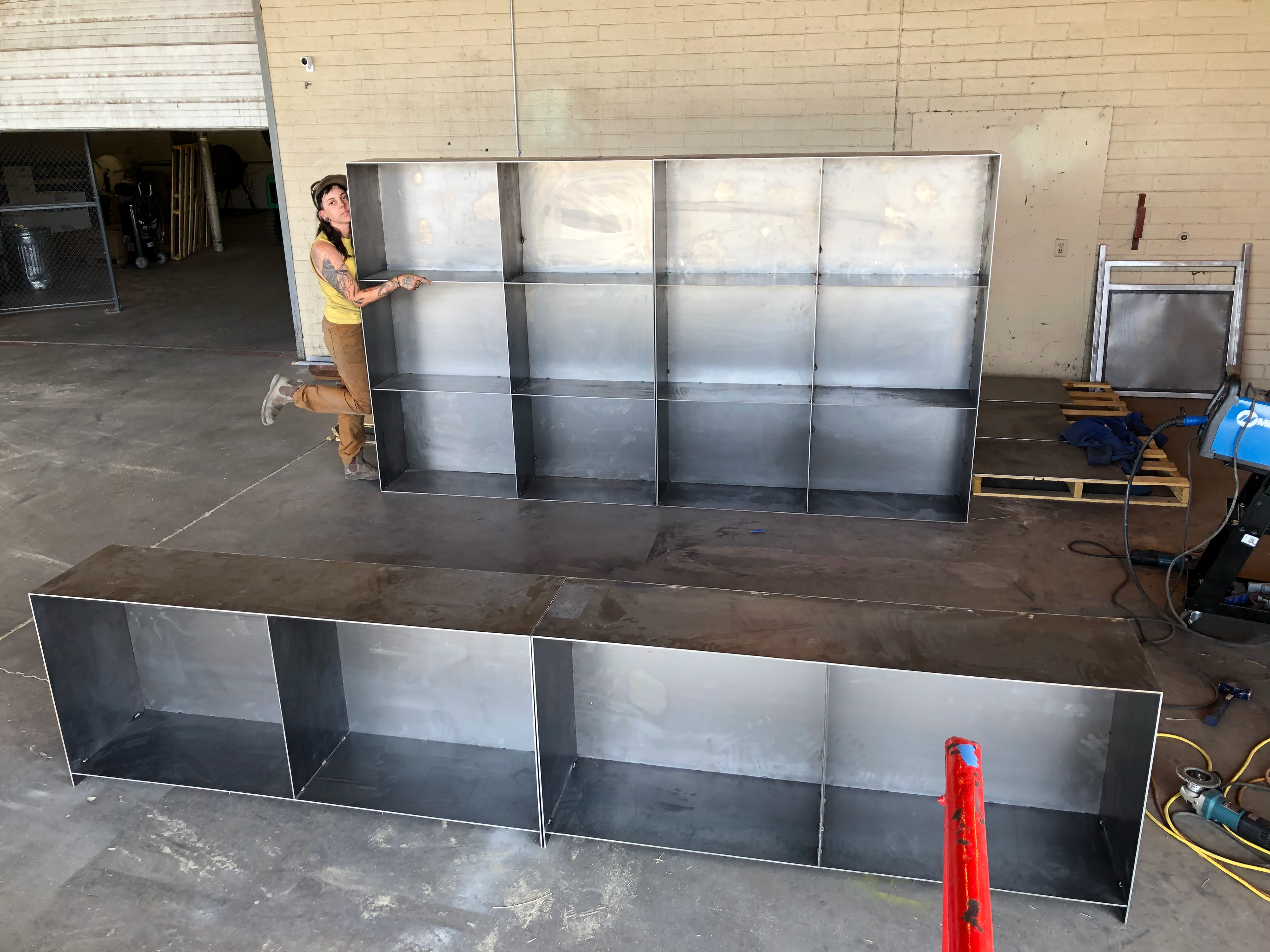Unfinished bases infront of unfinished top pieces. Me for scale.
