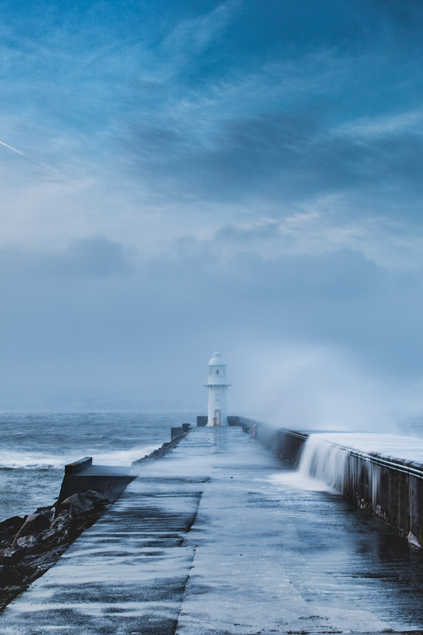 The harbour town of Brixham in Devon is sheltered from the ferocious English Channel by a half mile long breakwater. I headed down for sunset was not prepared for what I was confronted by! To the right of this image the breakwater drops down to the ocean about 5-6ft below, but the power of the wind on this day sent waves up the 6ft wall and 10ft into the air! Walking down the path to the end I got more then a little bit wet by waves crashing over the edge, it's truly awe inspriring to witness the raw power of nature like this.