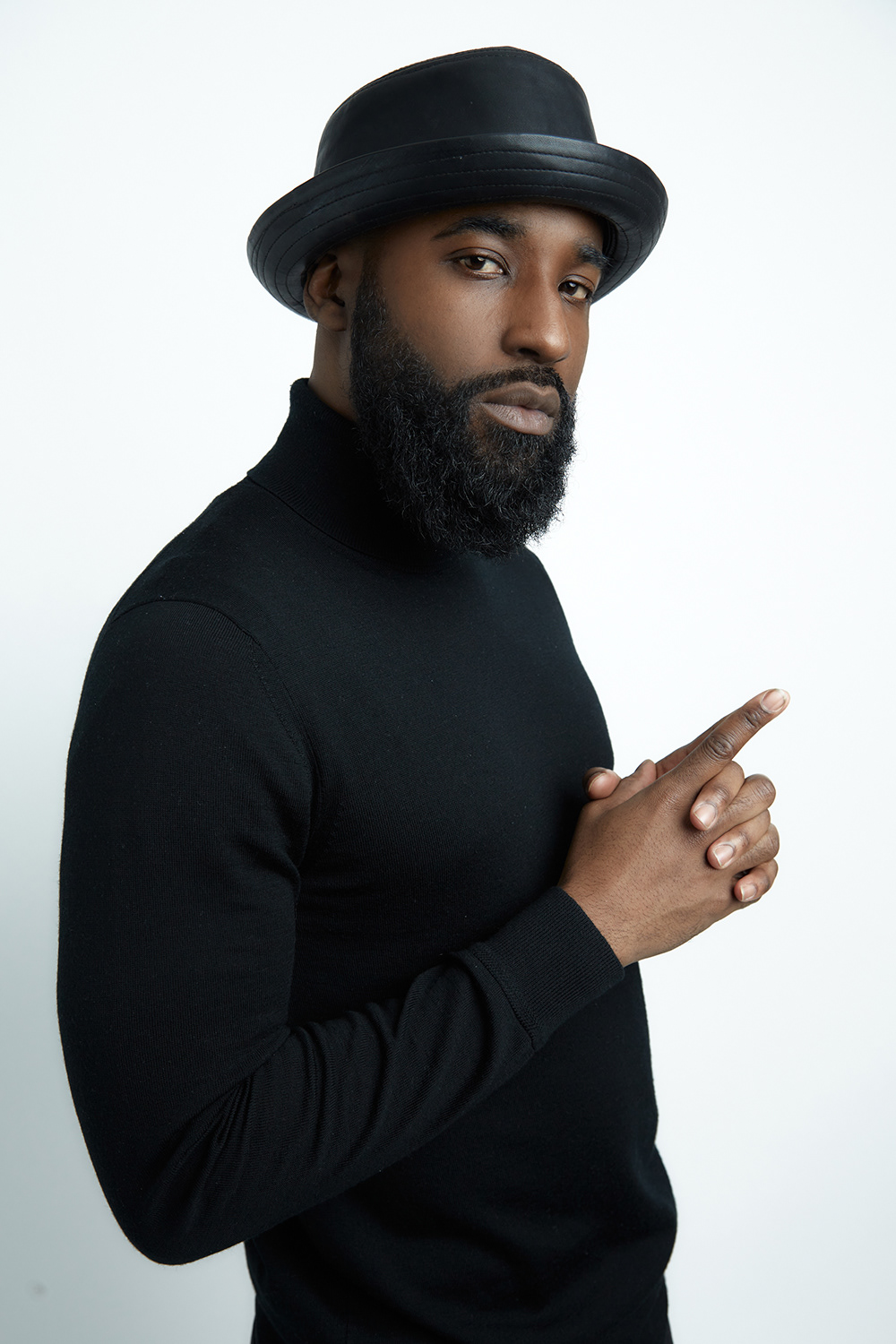 musician in black turtleneck and hat for a portfolio update