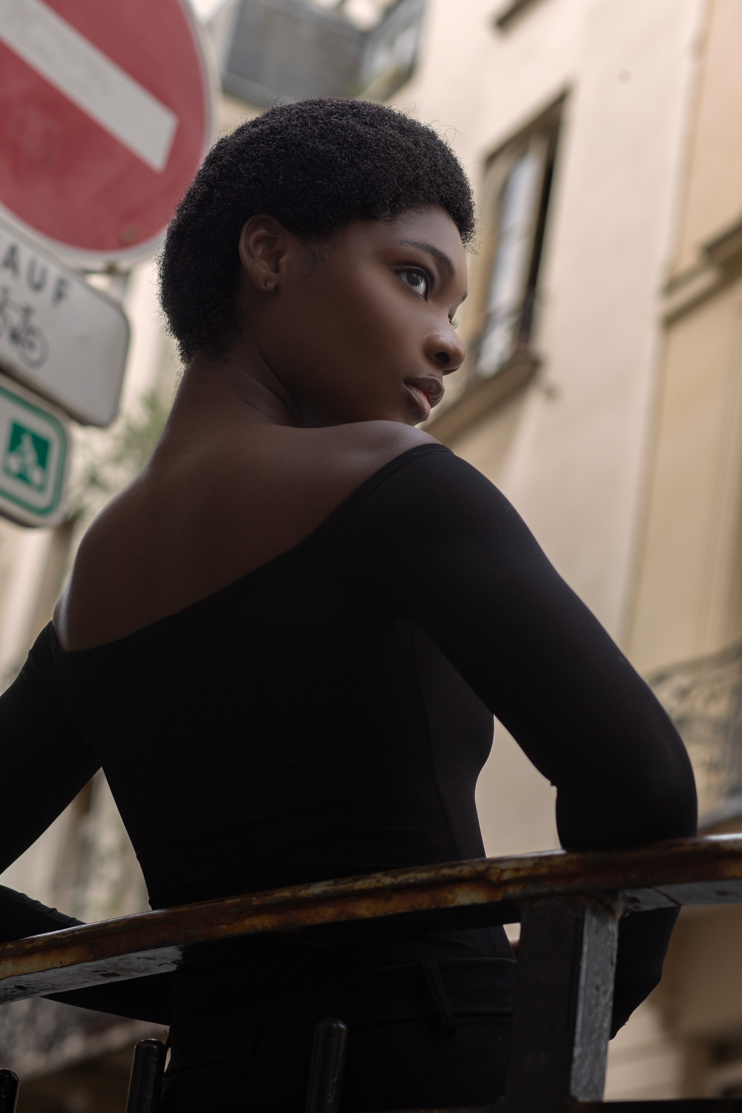 Carla posing confidently on a lively Paris street for a portrait photography project