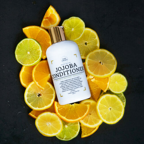 Haircare product on a bed of limes, oranges and lemonsfor lifestyle shoot