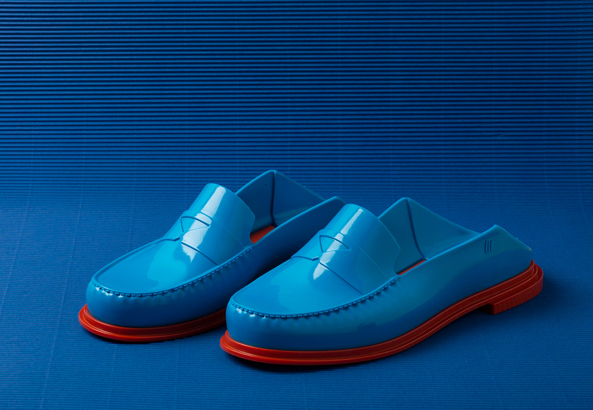 blue mellissa shoes on a blue backdrop for fashion campaign 