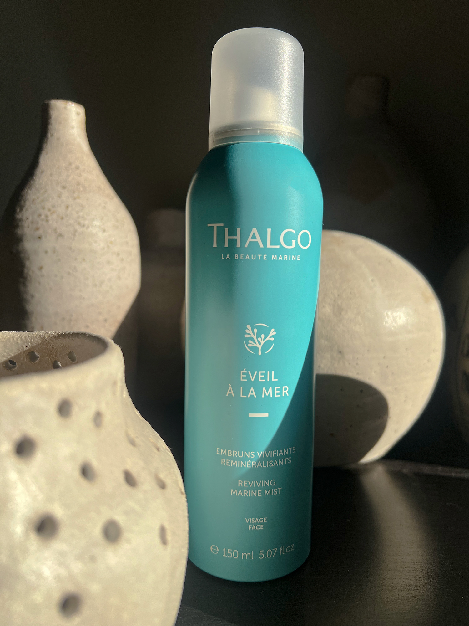 Mist spray by thalgo uk in the line of the sun with some cool vases around it