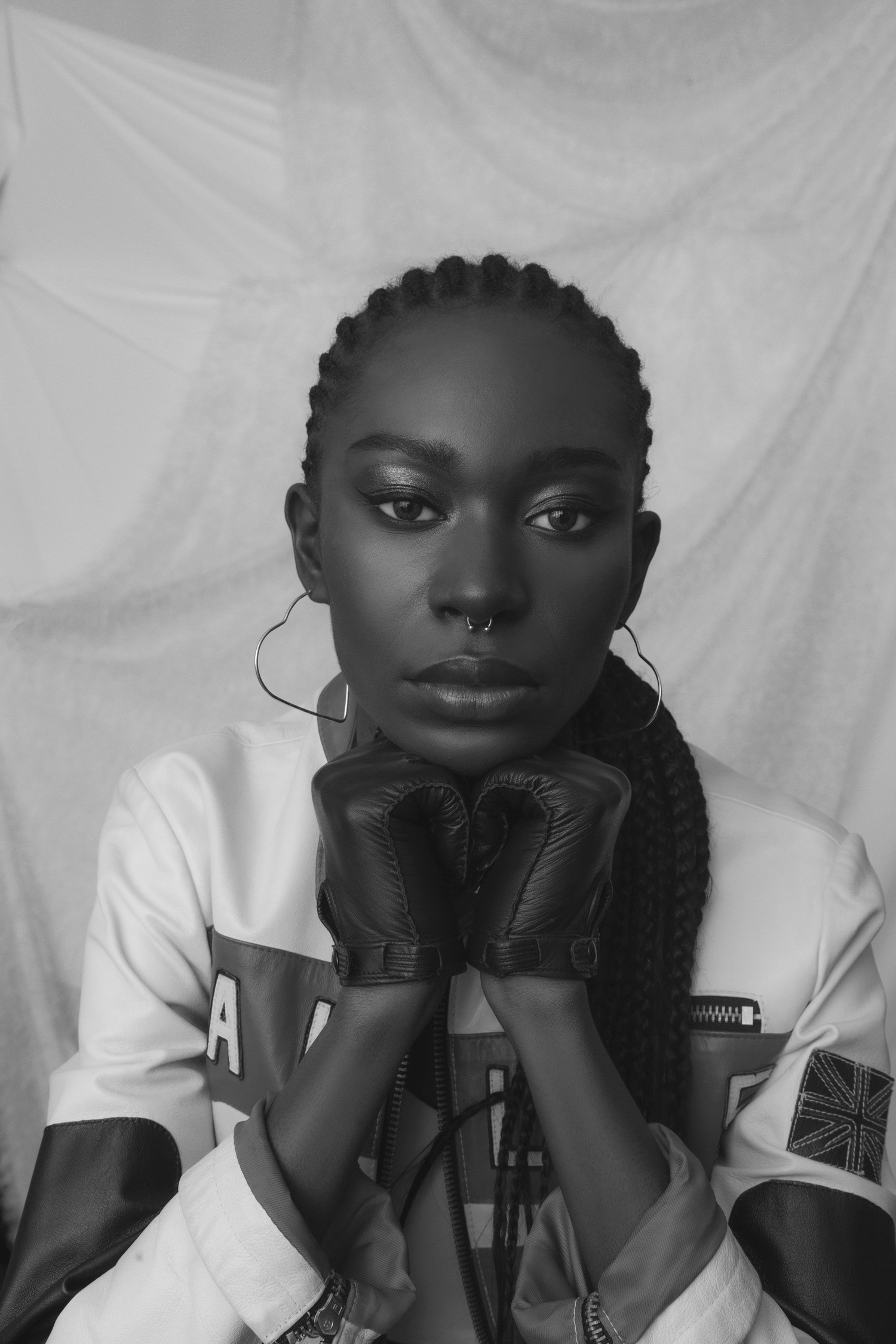 A bold look from model sitting in a chair fiercely looking into the camera