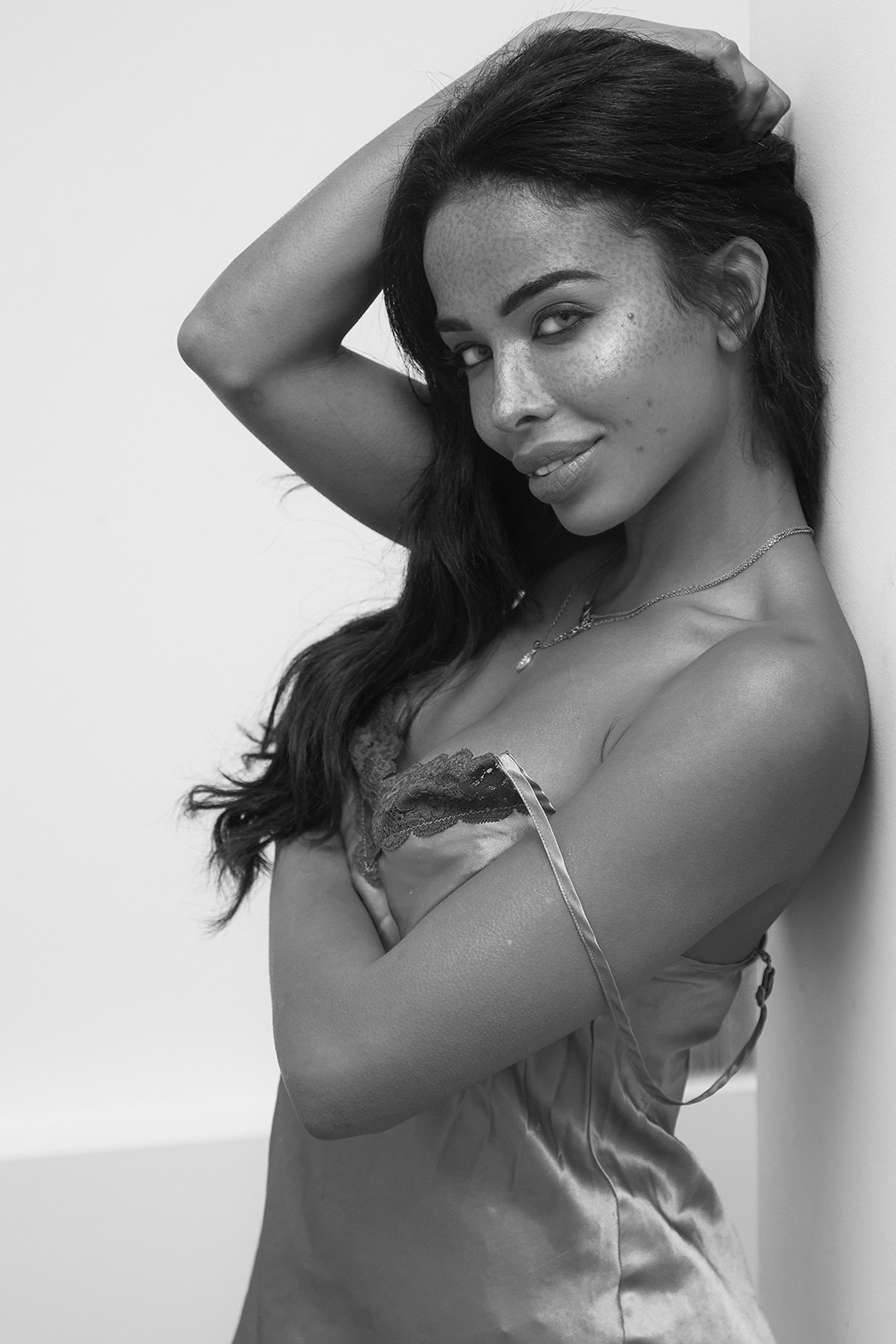 Stunning black and white of model comfortable at home smiling in her night gown for a fashion brand