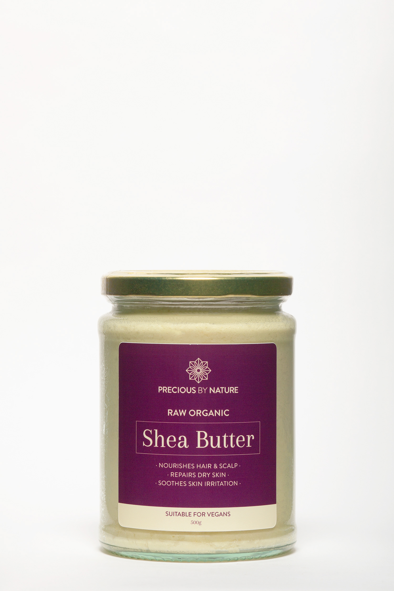 shea butter jar on a table with a white background