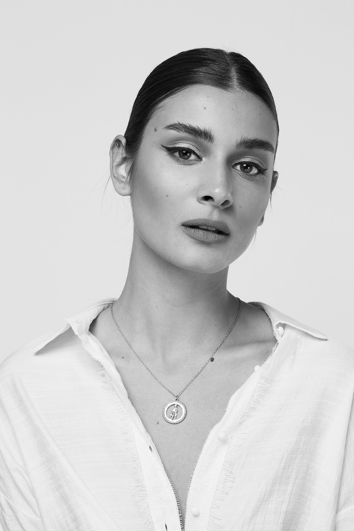 A lovely black and white shot of model styling a minimalistic look for a fashion shoot