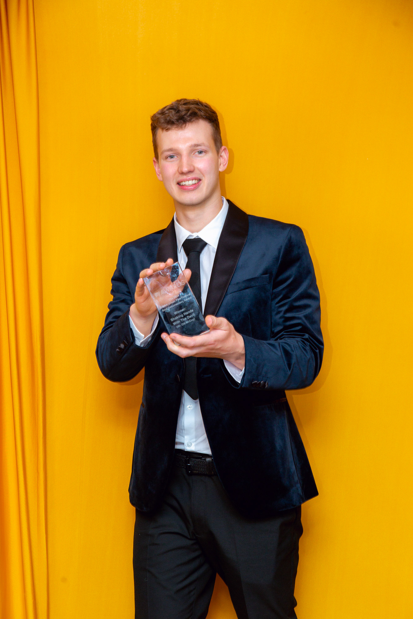 Winner in blue tux with his award -  BUFF AWARDS 2024