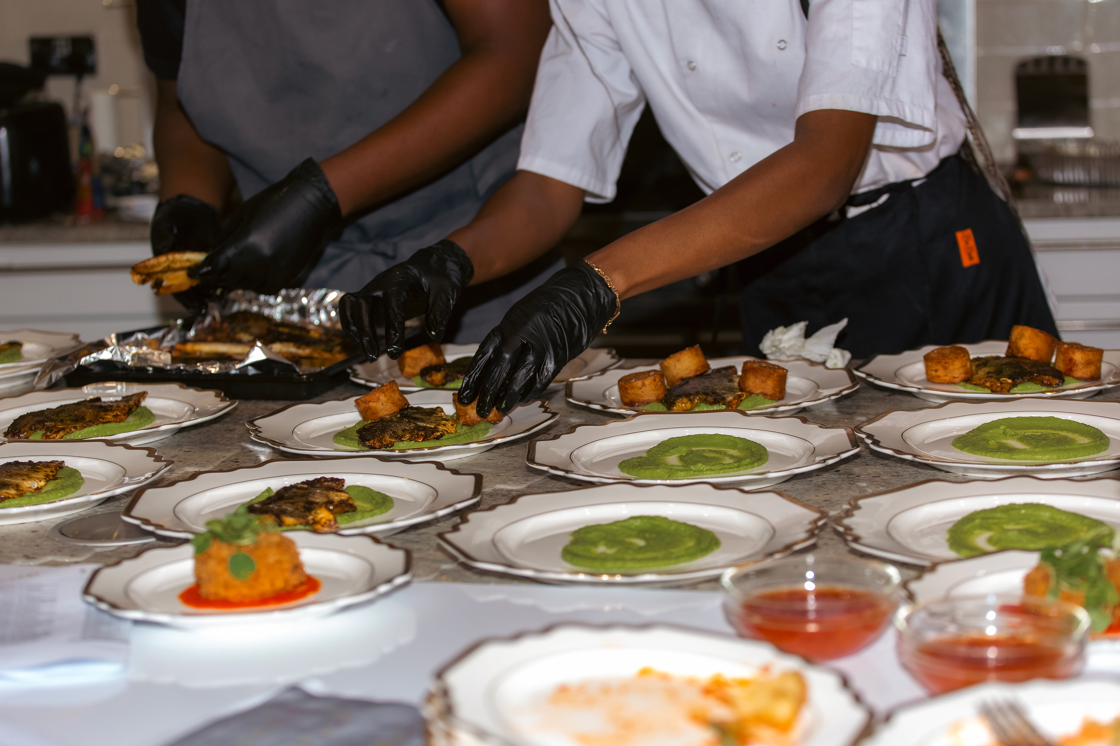 The event caterer adding the final touches to the food prepared at the event