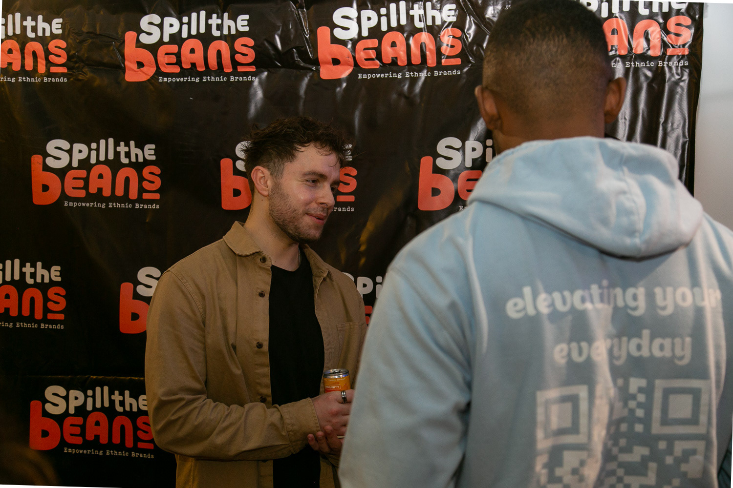 A spill the beans backdrop being used to host interviews at the event