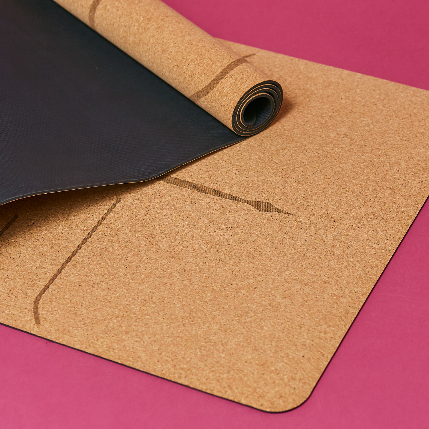 cork yoga mat on a pink backdrop