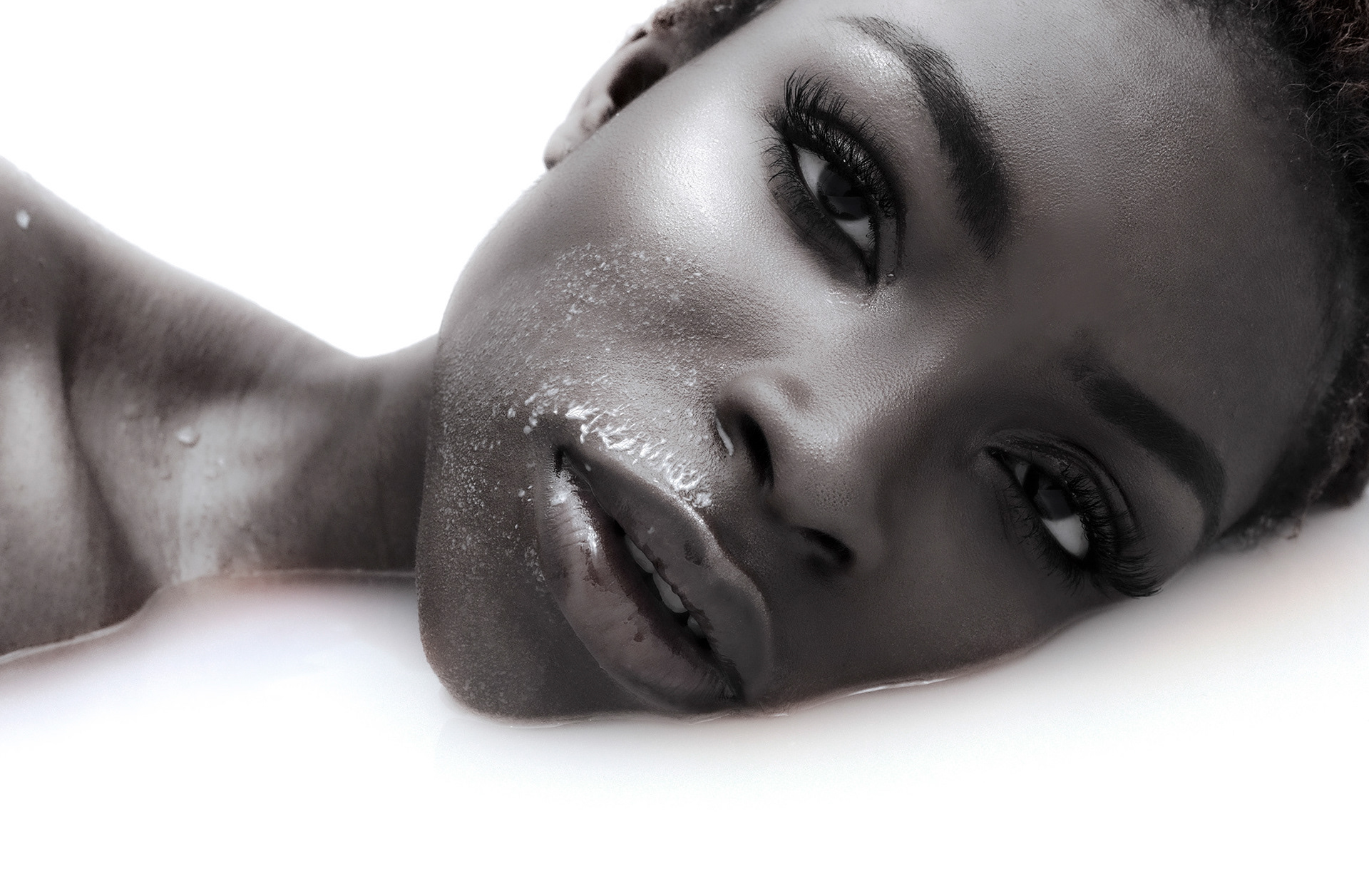 Model Wura posing confidently in a milk bath, captured for a creative photography project.