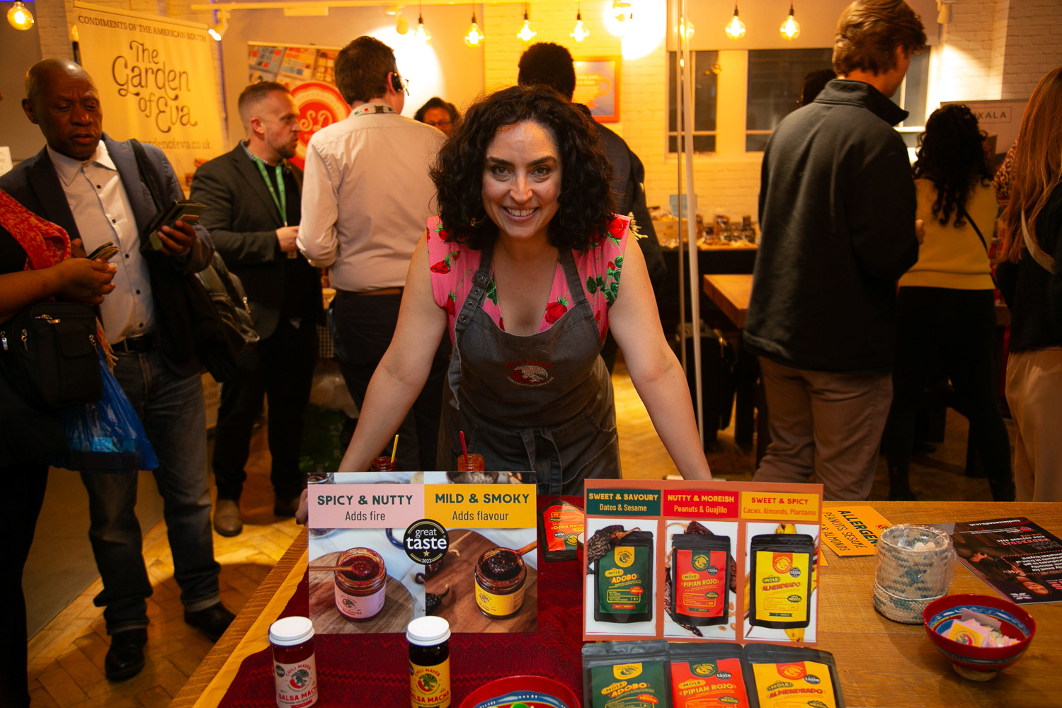 A producer with at her table showing her selection of cooking and seasoning products 