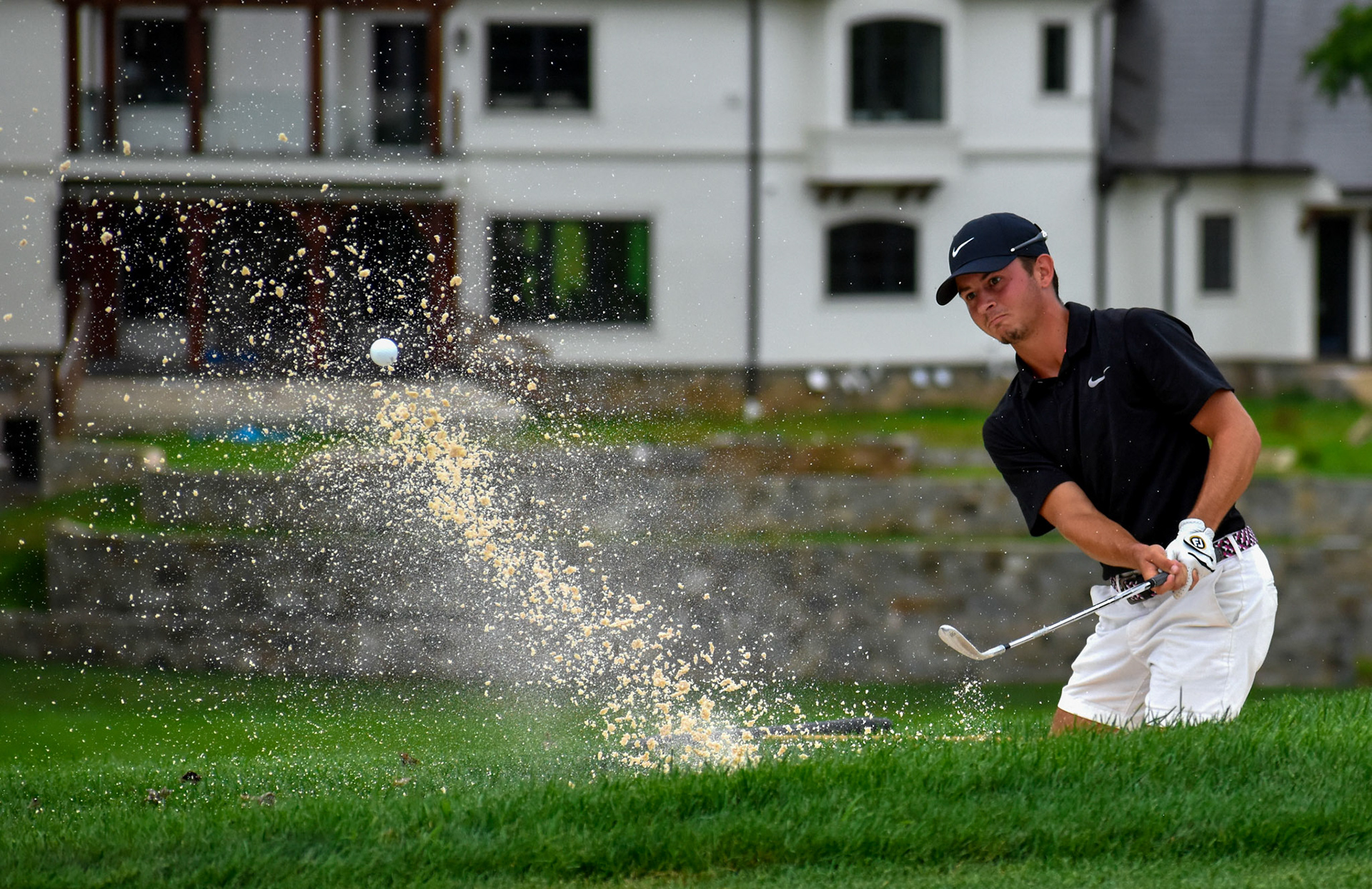 Peyton Spangler hits out of a buried lie in the bunker on 7.
