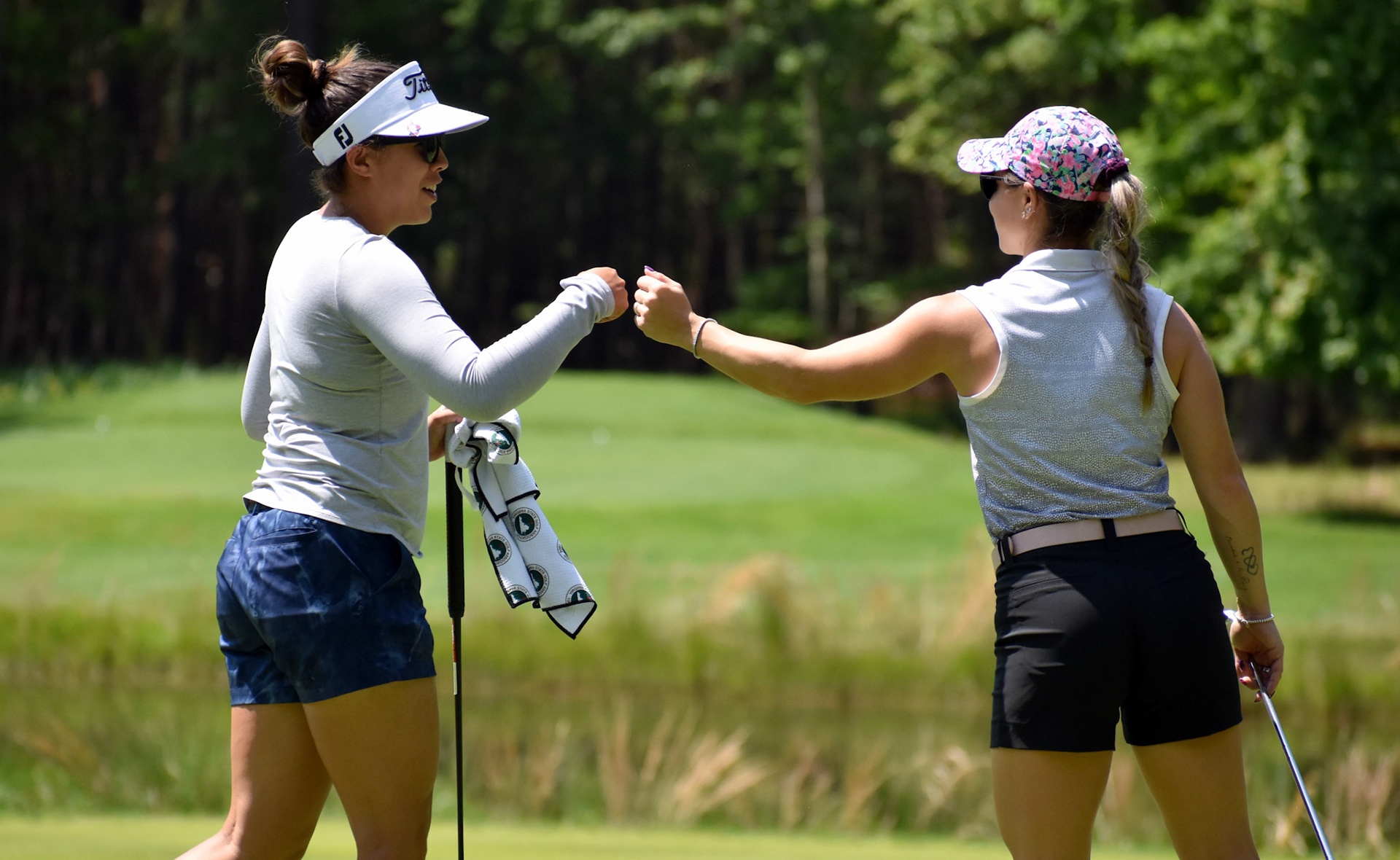 Lauren Greenlief and Alexandra Austin celebrate Greenlief's birdie on 12.