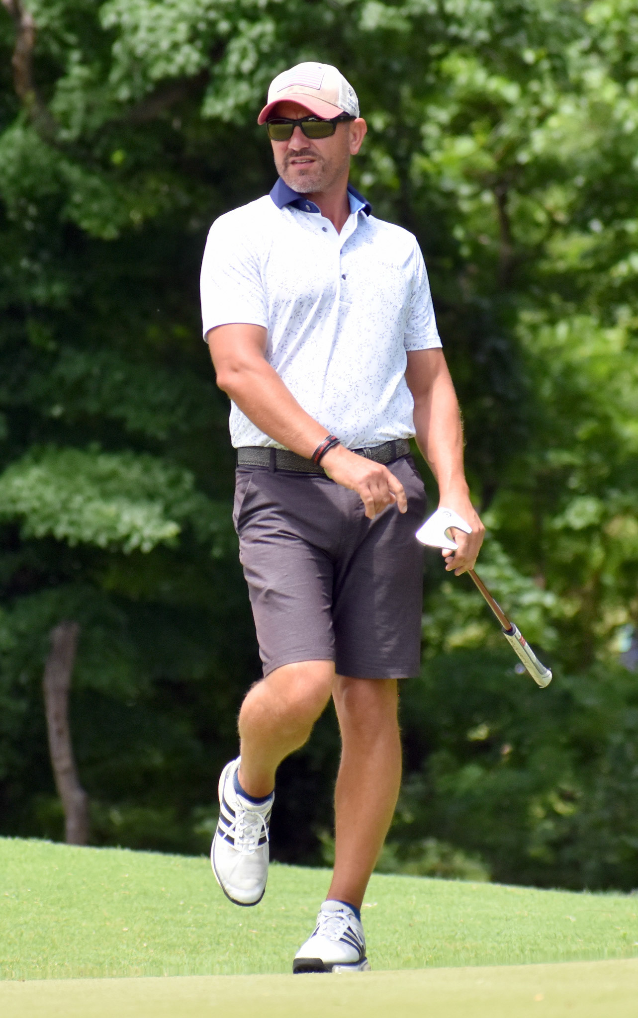 Patrick Bogue tries to will his putt into the hole on 13.