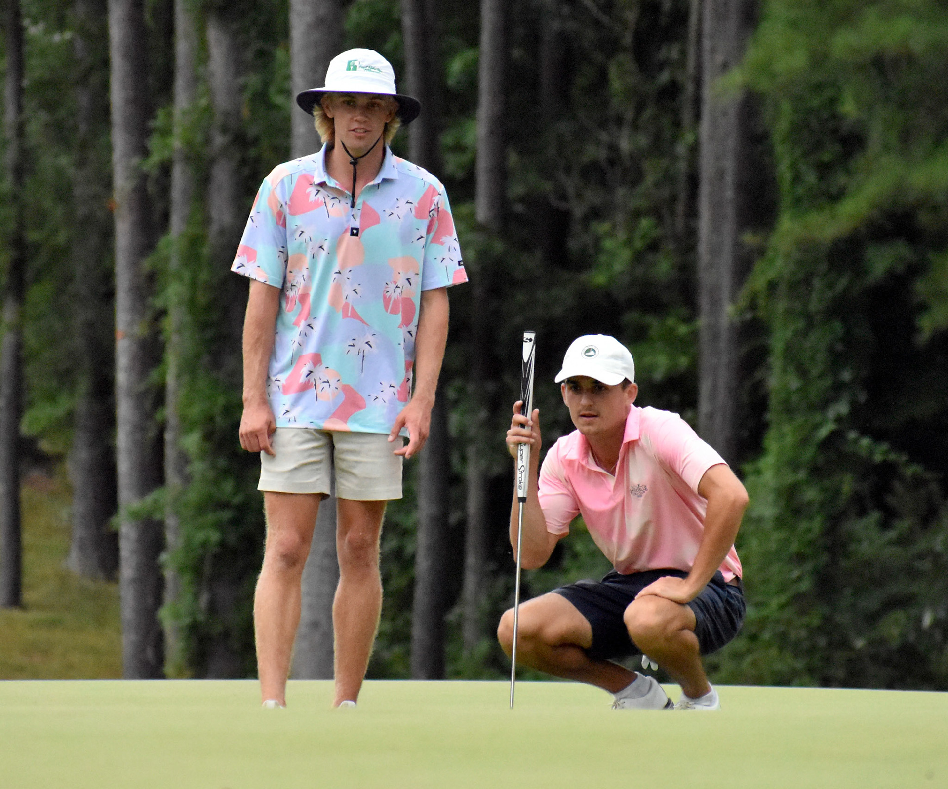 Nick Taliaferro and Channing Blevins read a putt on 14