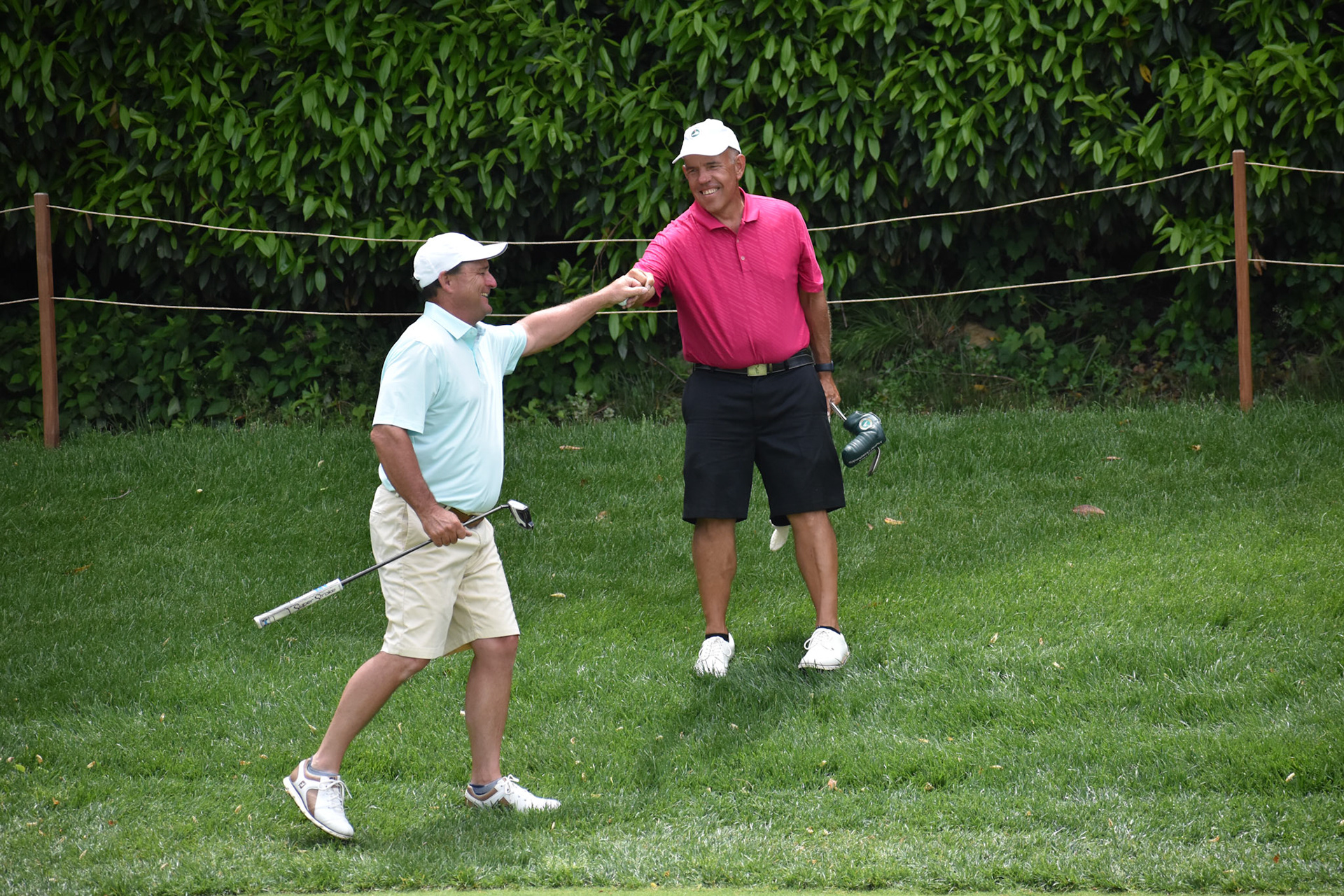 Jon Hurst and Buck Brittain celebrate after Brittain chipped in for birdie on 12.