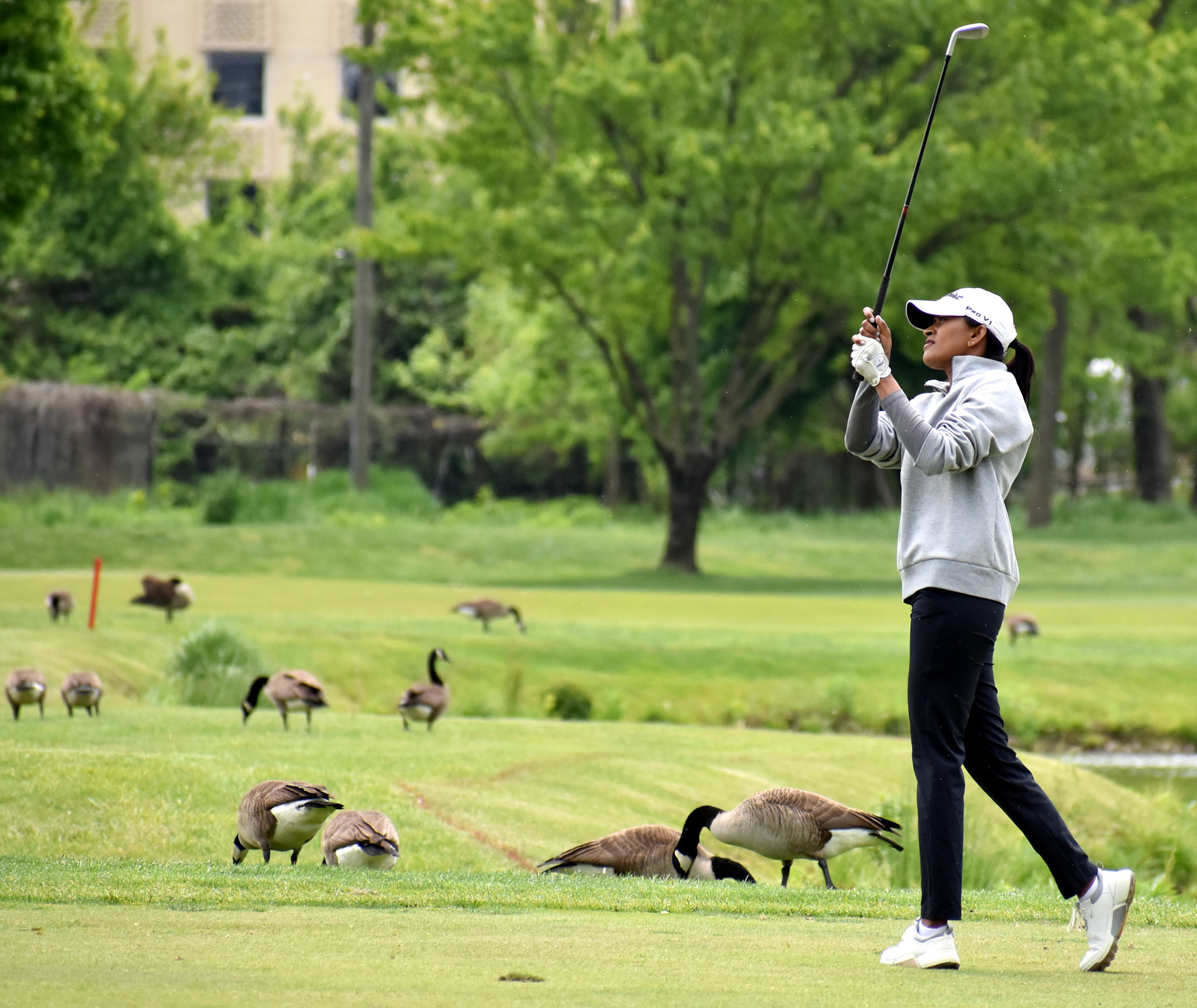 Karishma Thiagaraj hits her approach 7 seven while the gaggle in the gallery looks on.