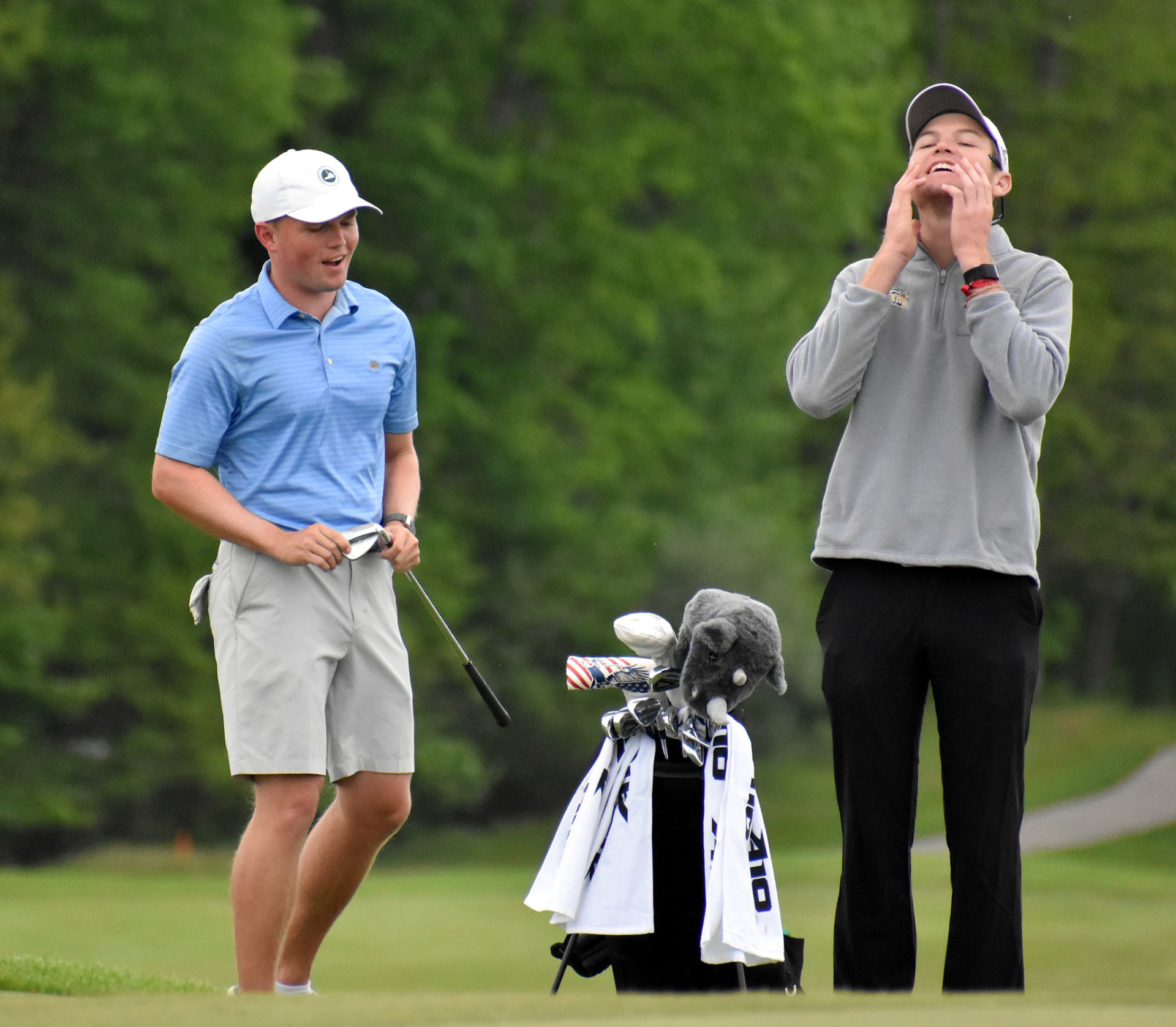 Ryan Monastero and his caddie react after Monastero nearly chipped in for eagle on 13.