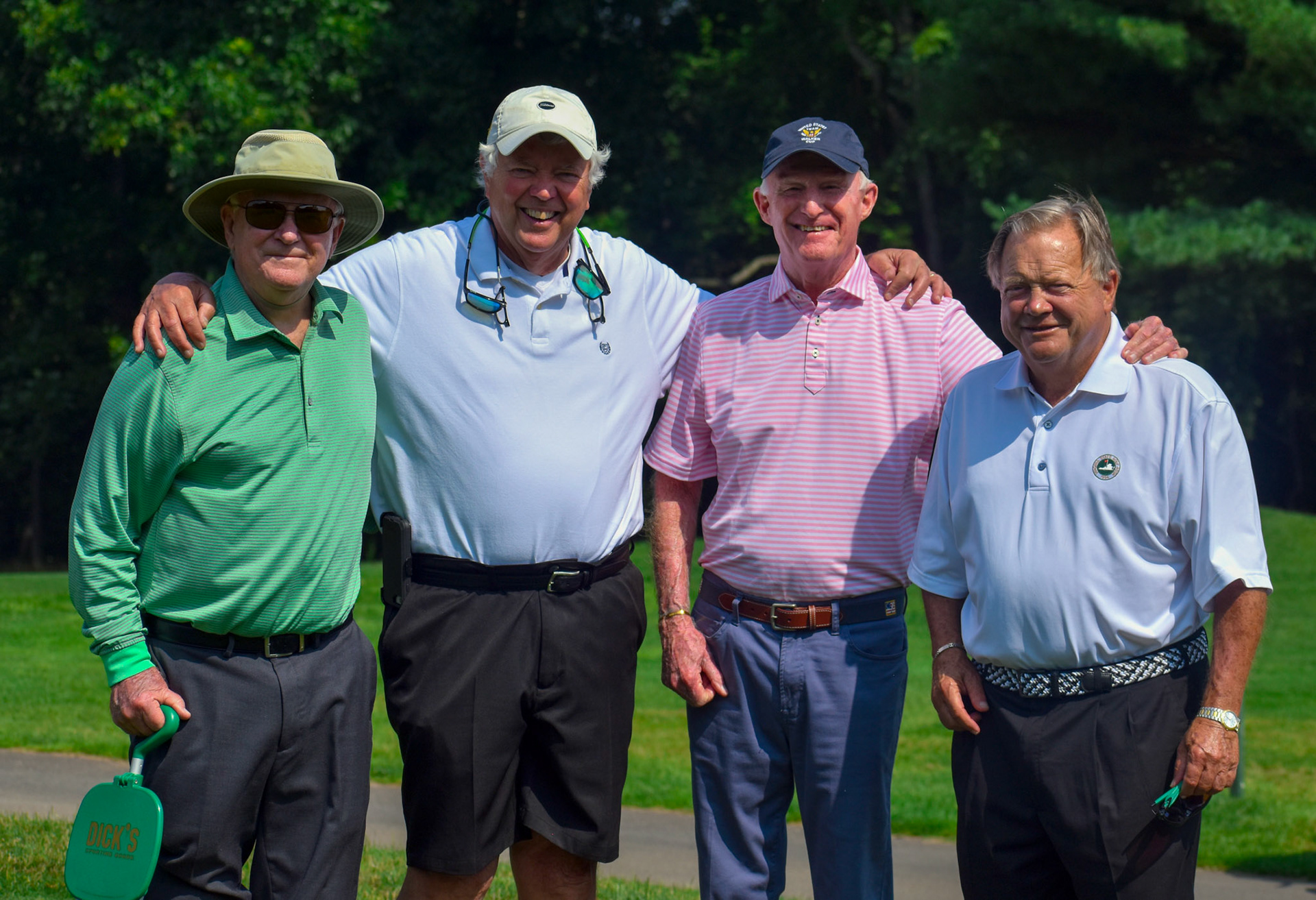 Virginia golf legend Wright Garrett, Rick Bendall, Vinny Giles, and Harry Lea catch the action.