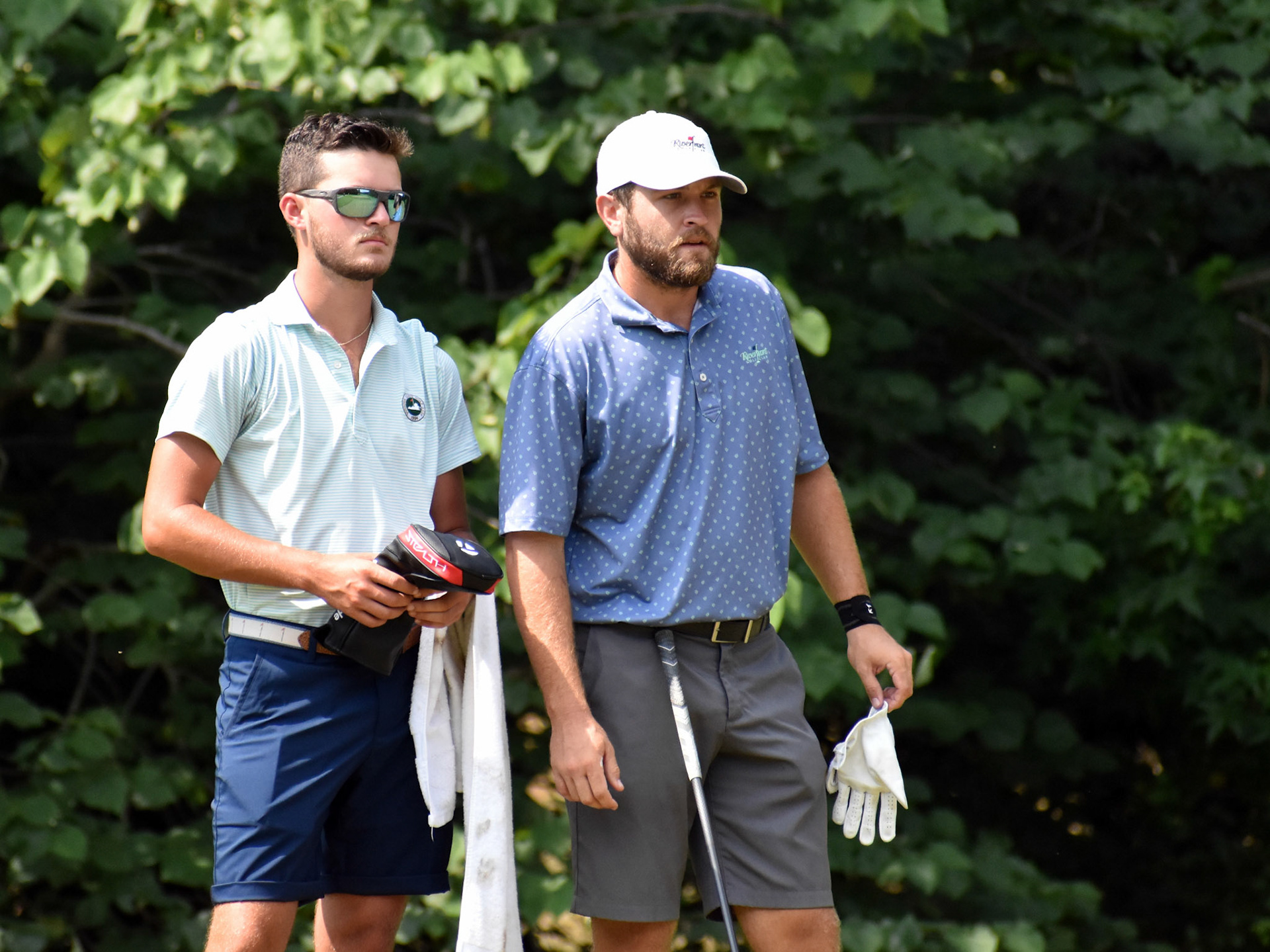Alston Newsom, right, consults with ace caddie Cullen Campbell before teeing off on 16